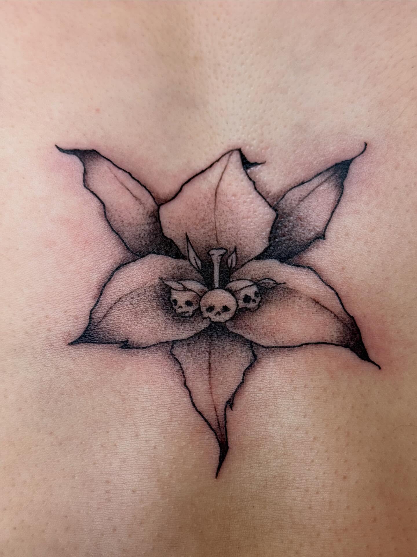 Flower with skulls dark realism tattoo on the chest by šianca٠࣪ā
