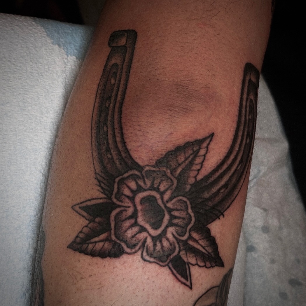 Horseshoe and flower American traditional tattoo on the forearm by Kat McCoy Guidera, Nashville, Tennessee