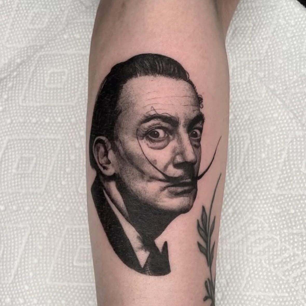 Salvador dali realism tattoo on the forearm by Dylan Coverdale