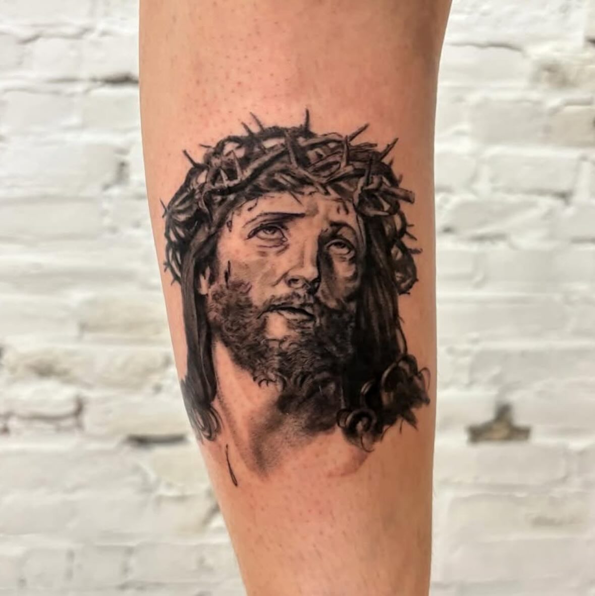 Jesus Christ realism tattoo on the forearm by Dylan Coverdale