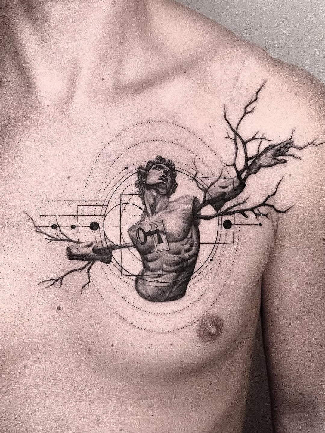 Statue with tree branches geometric tattoo on the chest by János Bozóki, Budapest, Hungary