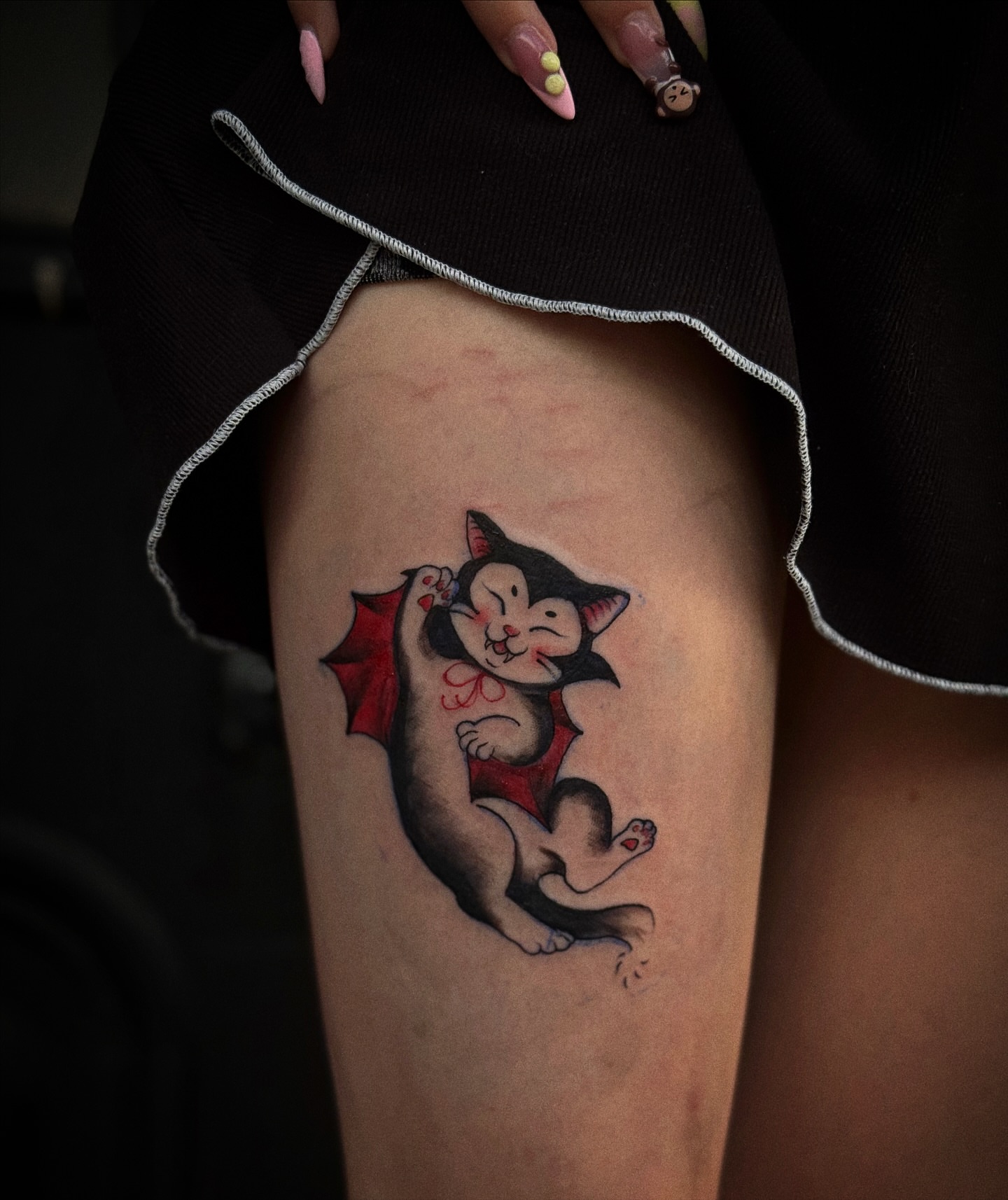 Cat with wings new school tattoo on the thigh by 𝙹𝙰𝚉𝚉 𝙲𝙷𝙰𝙾