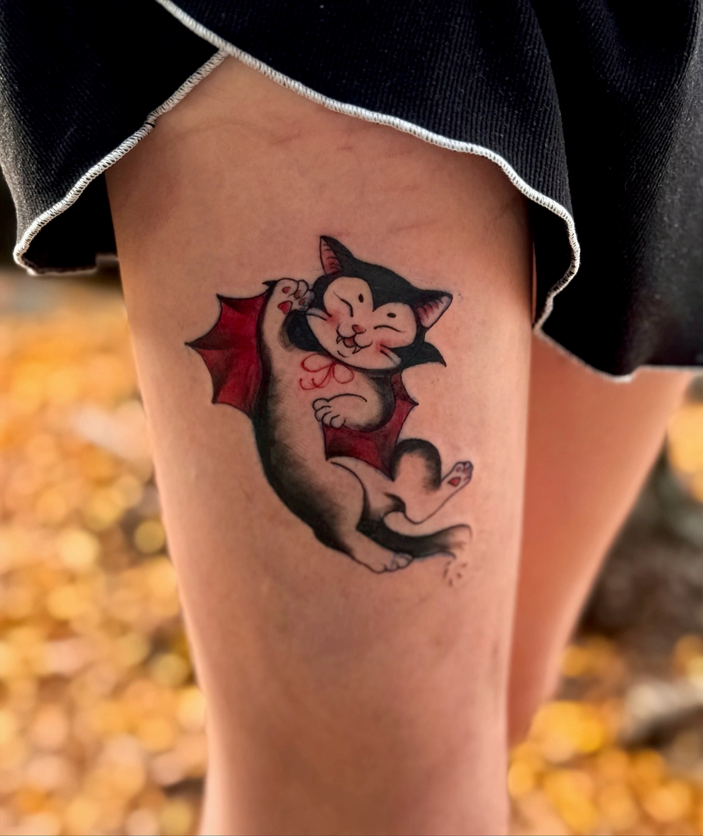 Cat with wings American traditional tattoo on the thigh by 𝙹𝙰𝚉𝚉 𝙲𝙷𝙰𝙾