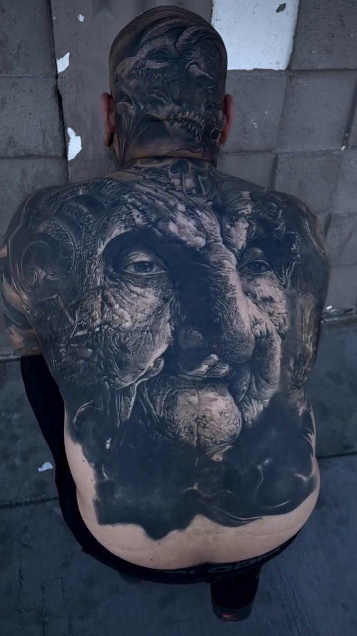 Demonic face and lion realism tattoo by Robert Hernandez