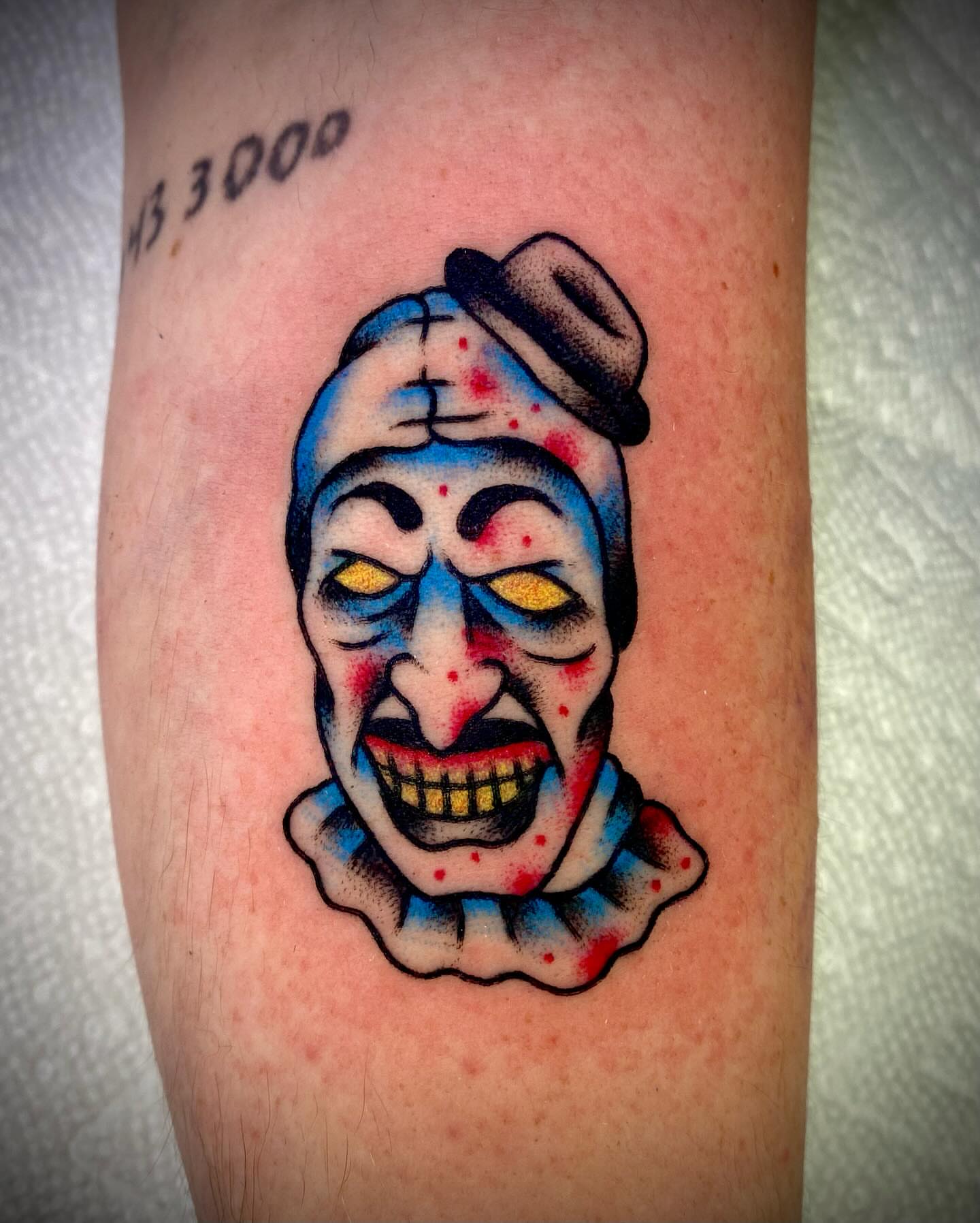 Clown American traditional tattoo on the forearm by Zach Knisley (Wiz)