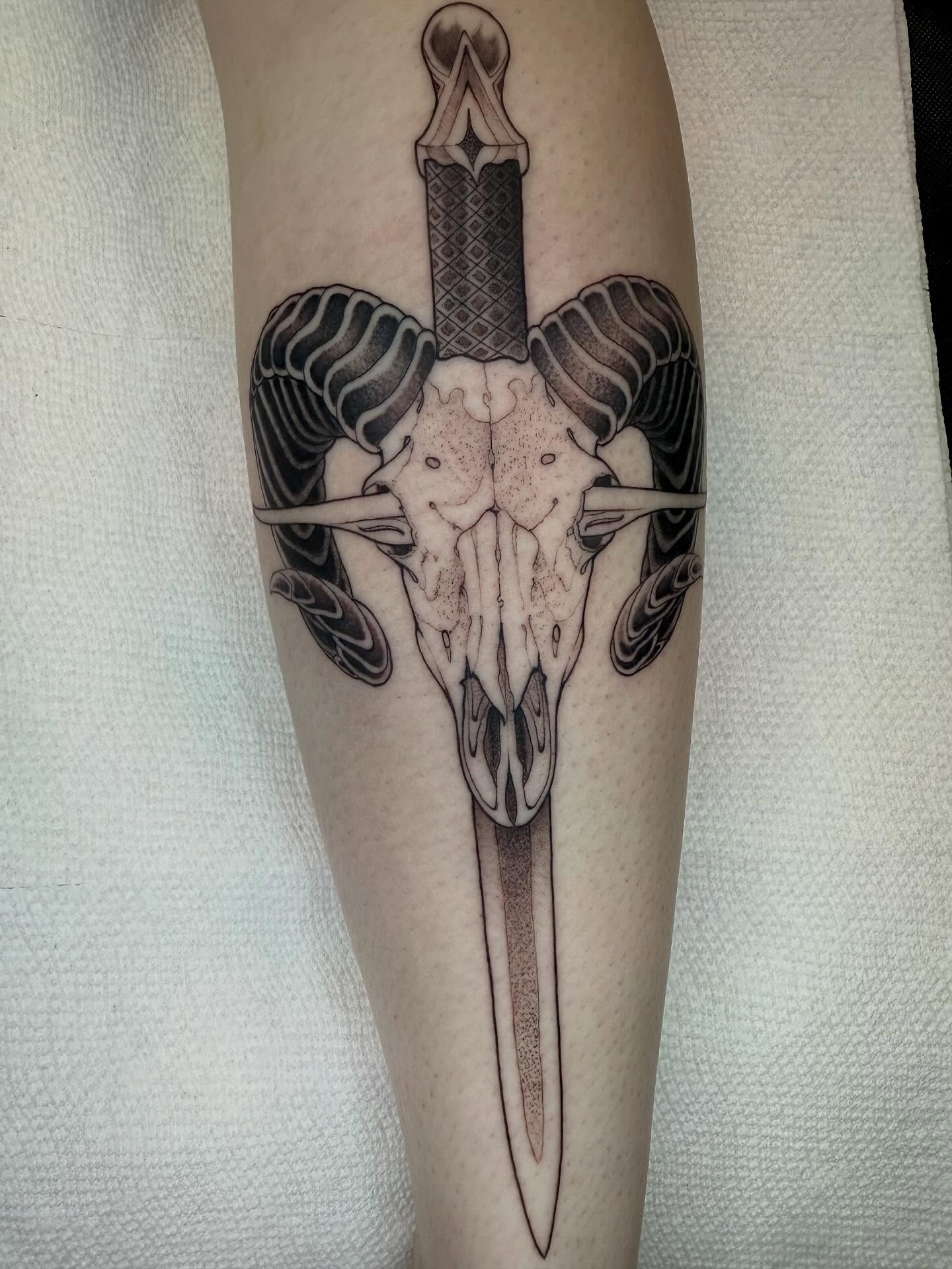 Ram skull with dagger dotwork tattoo on the forearm by Angelo Buonanno, Las Vegas, Nevada