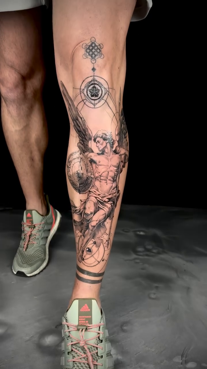 Angel with shield and globe realism tattoo by Apologies tattoo studios.