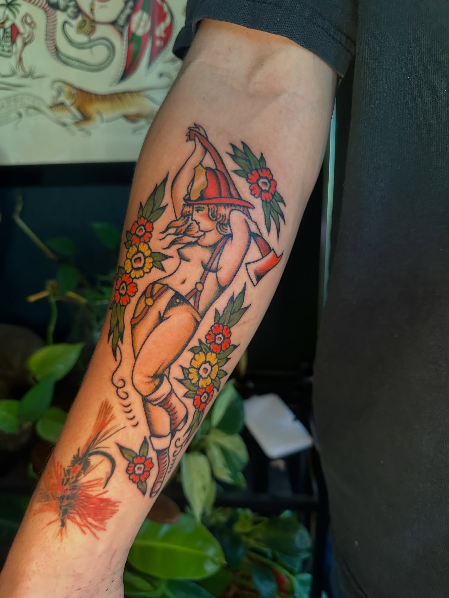 Firefighter pin-up American traditional tattoo on the forearm by Max Peterson