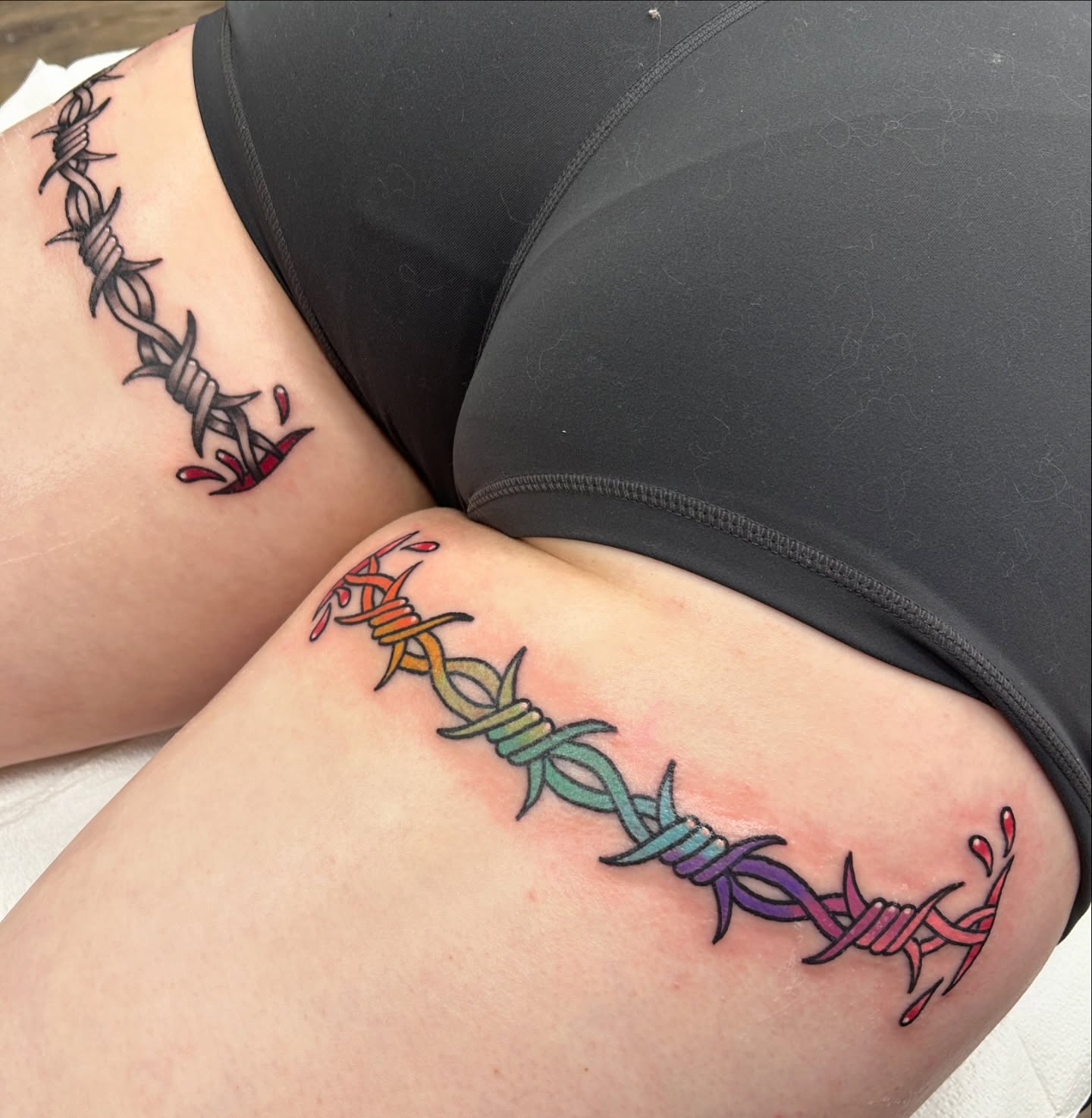 Barbed wire neo-traditional tattoo on the thigh by Courtney