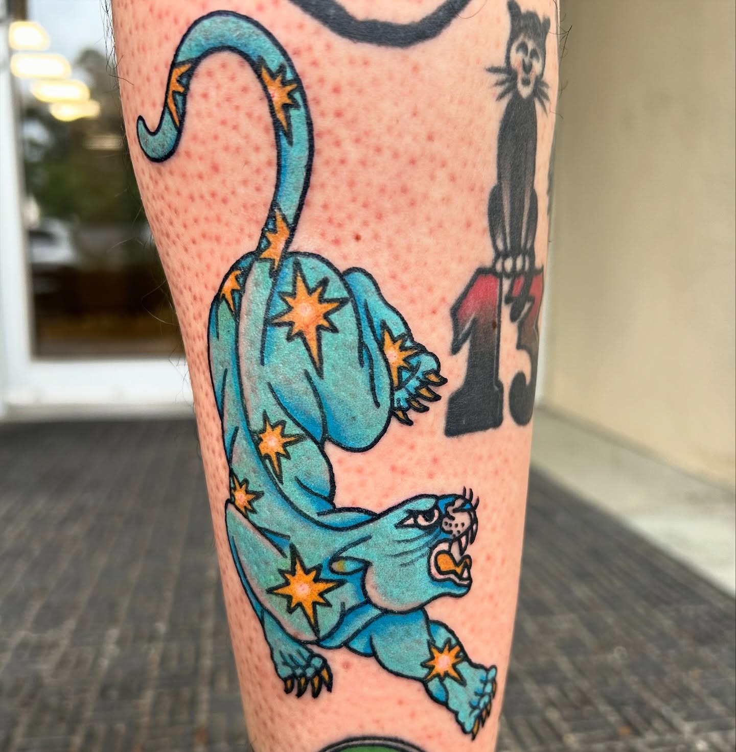 Panther with stars American traditional tattoo on the forearm by Courtney