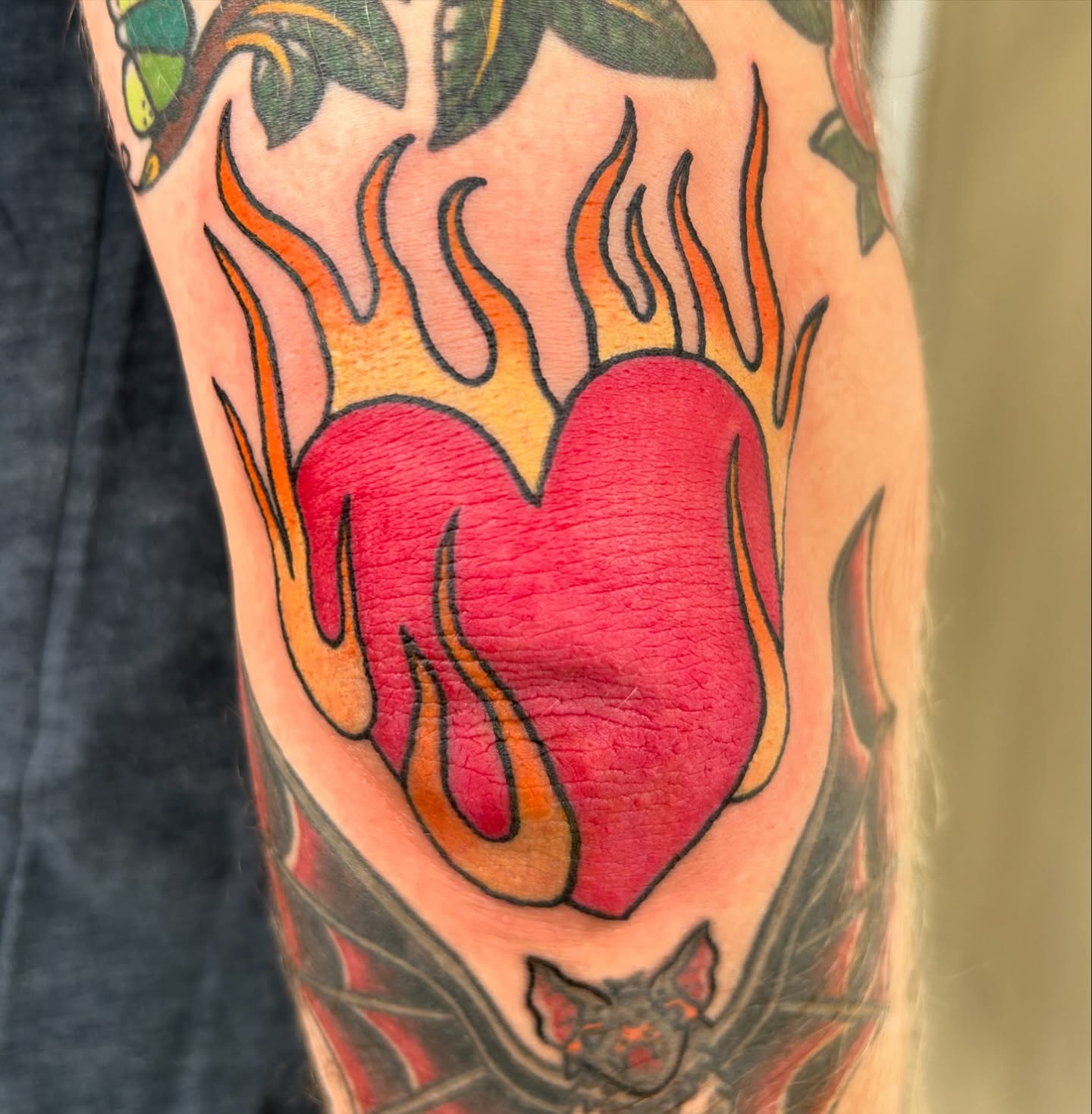 Flaming heart American traditional tattoo on the forearm by Courtney
