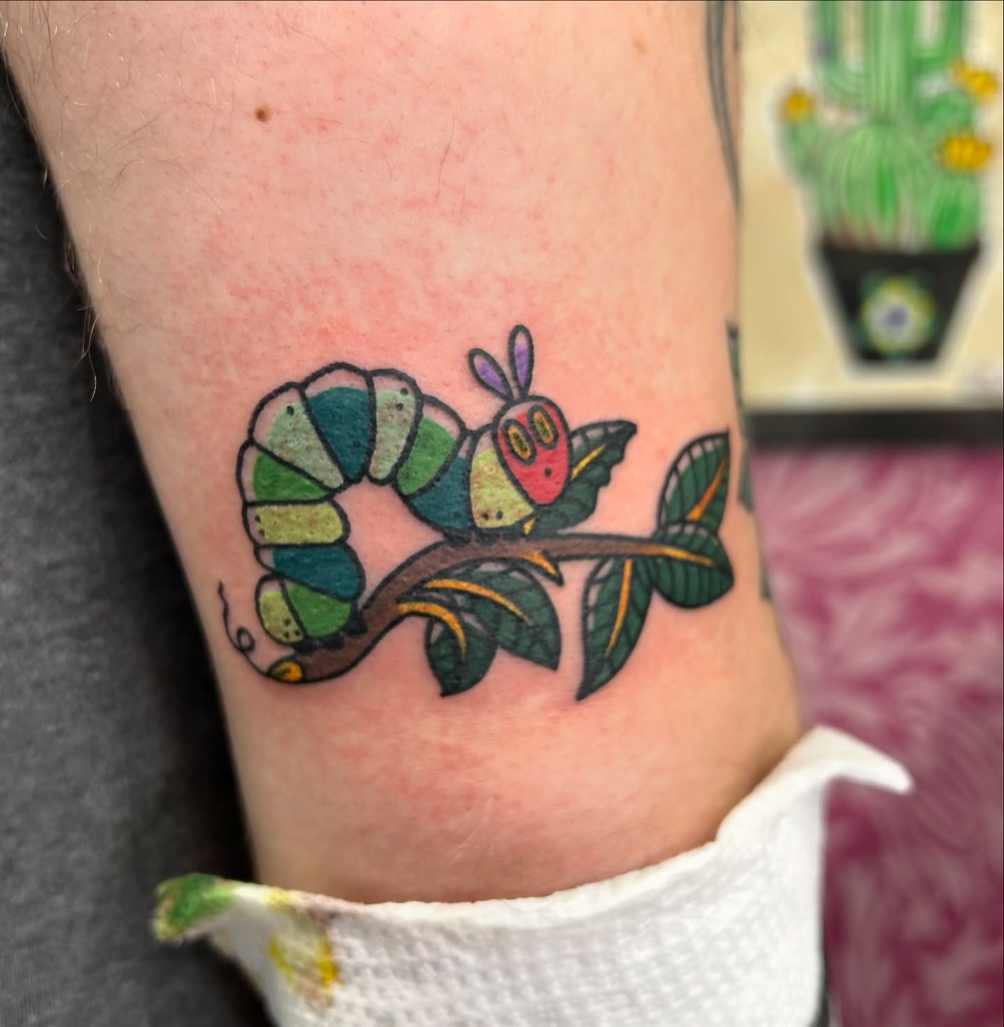 Worm on leaf new school tattoo on the forearm by Courtney