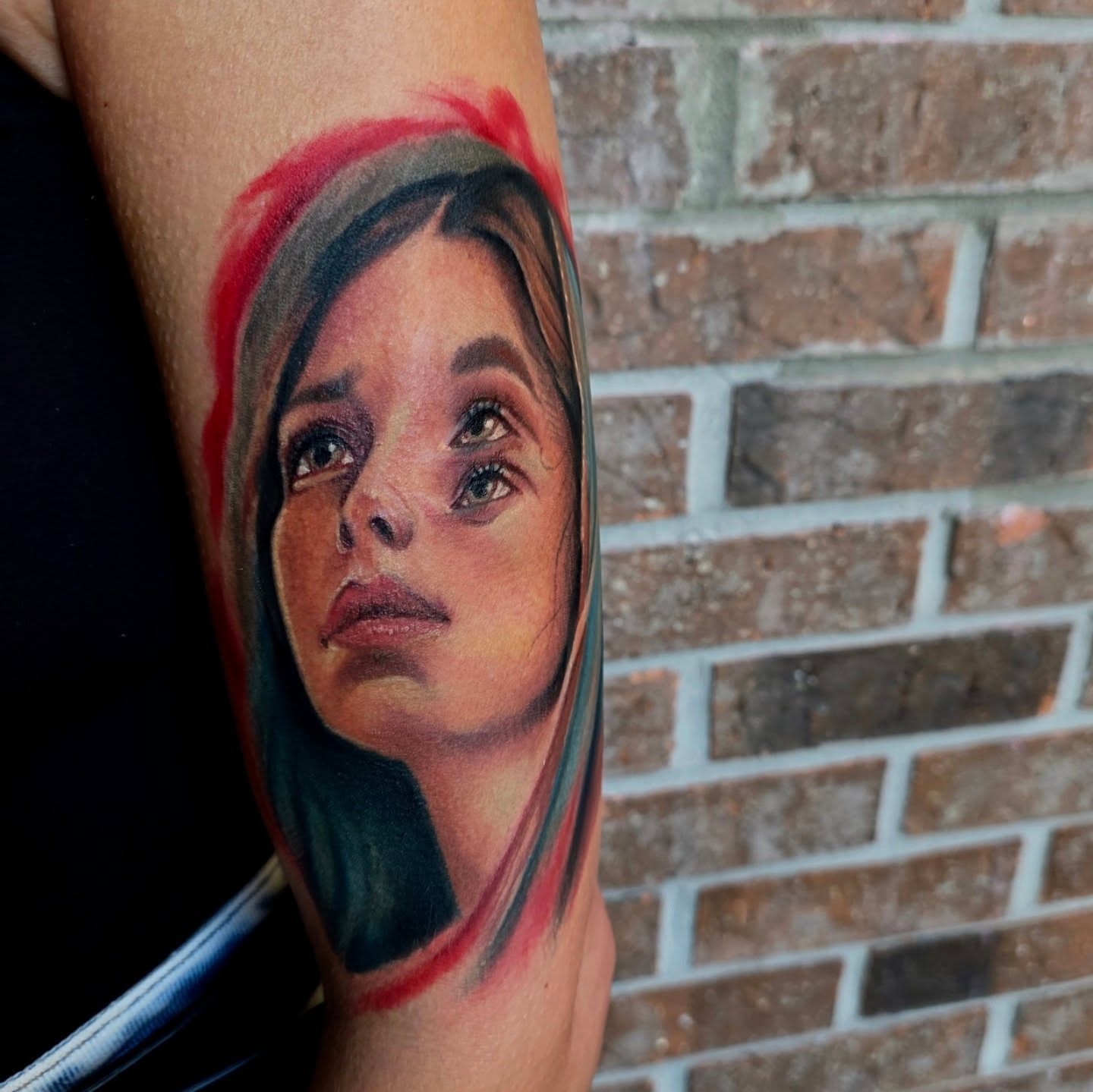 Portrait realism tattoo on the forearm by Michael Latendresse