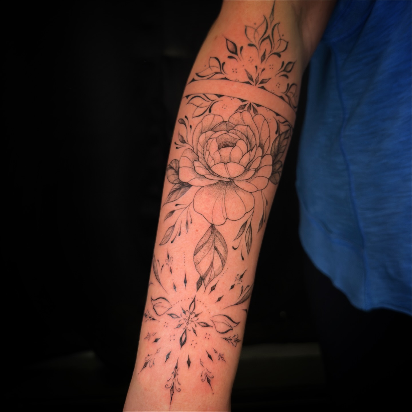 Floral bouquet black and grey tattoo on the forearm by Hues 🦤 Clarksville Fine Line and Blackwork