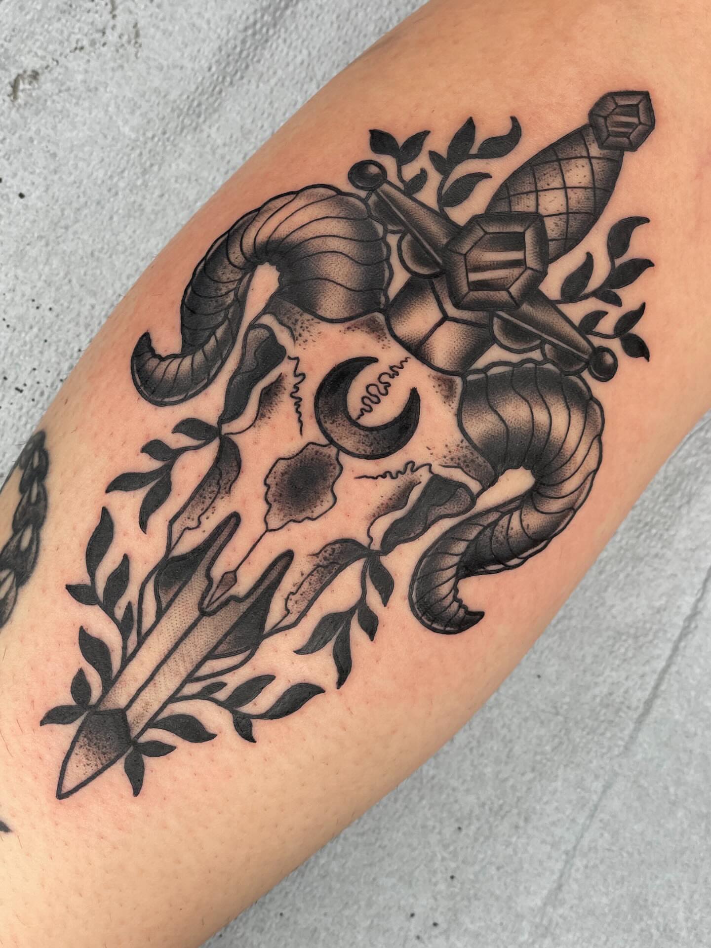 Ram skull and sword American traditional tattoo on the forearm by Beeker, Bellingham, Washington