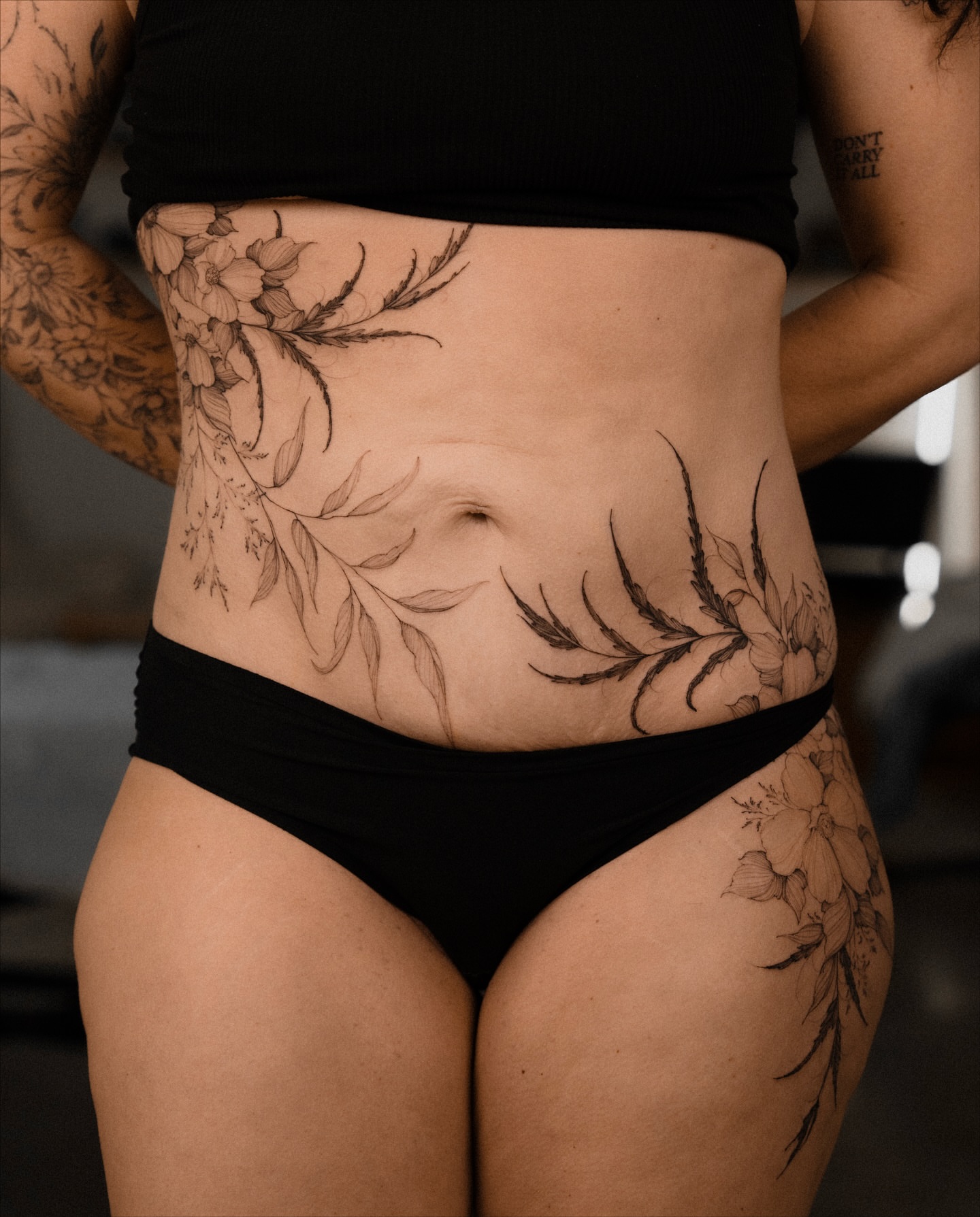 Floral black and grey tattoo on the torso by Marek