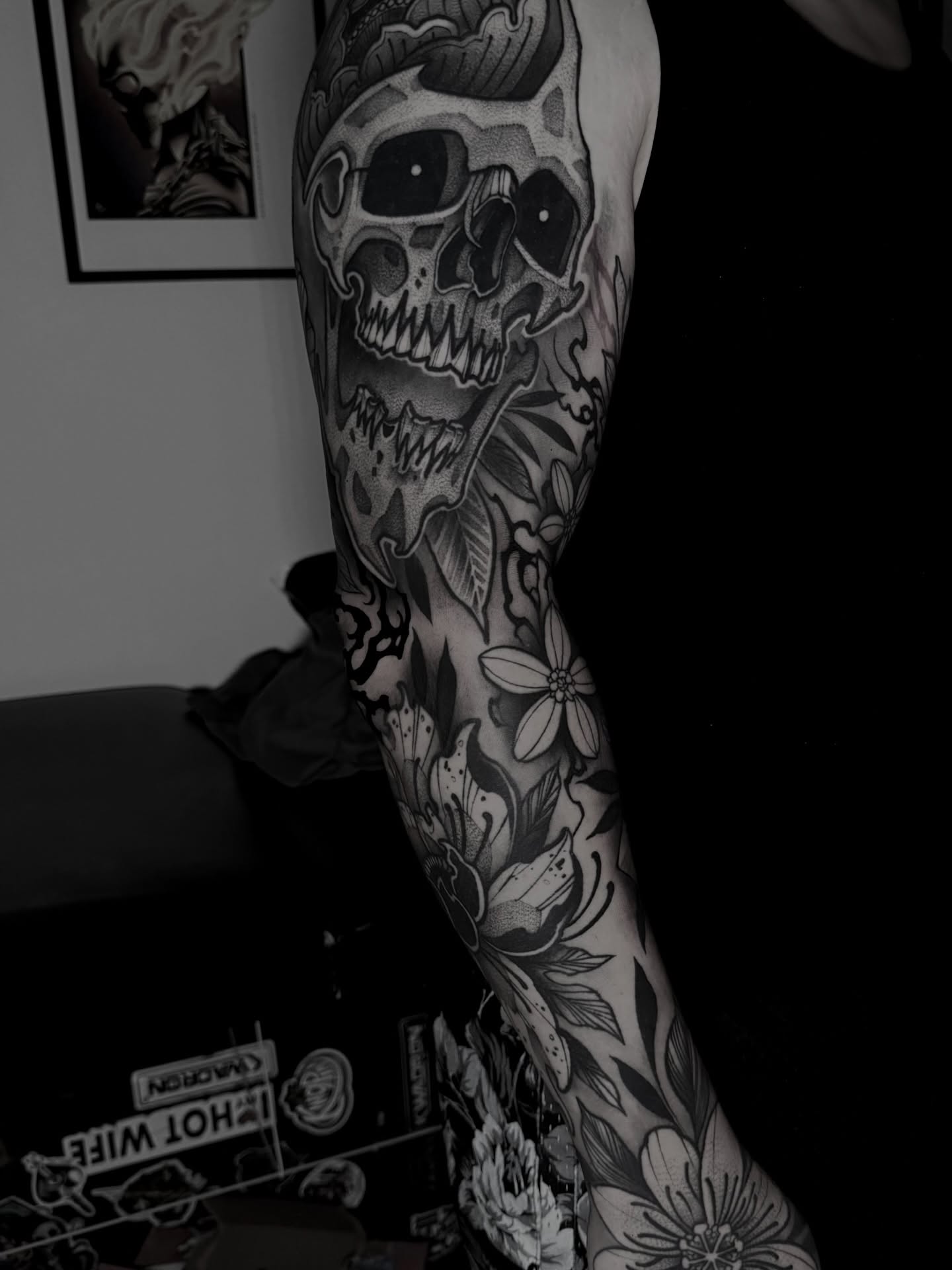 Skull and floral realism tattoo on the forearm by Clayton Smith (BEAR)