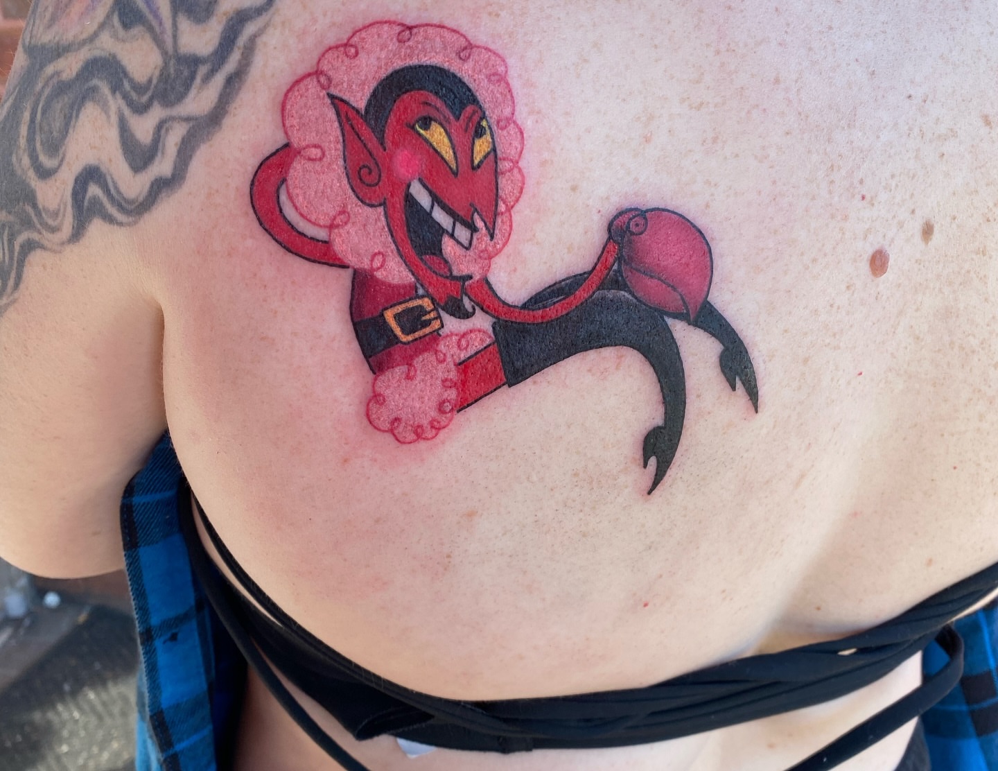 Red devil character anime tattoo on the back by Destinee DeFriece