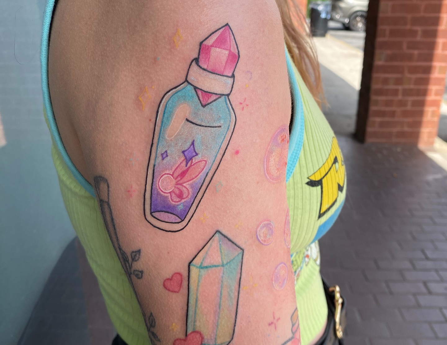 Crystal bottle new school tattoo on the forearm by Destinee DeFriece