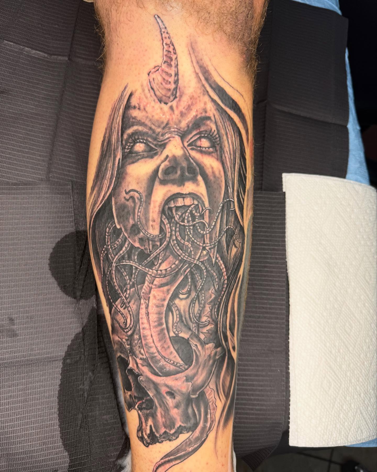 Demon dark realism tattoo on the forearm by Frank DeMao