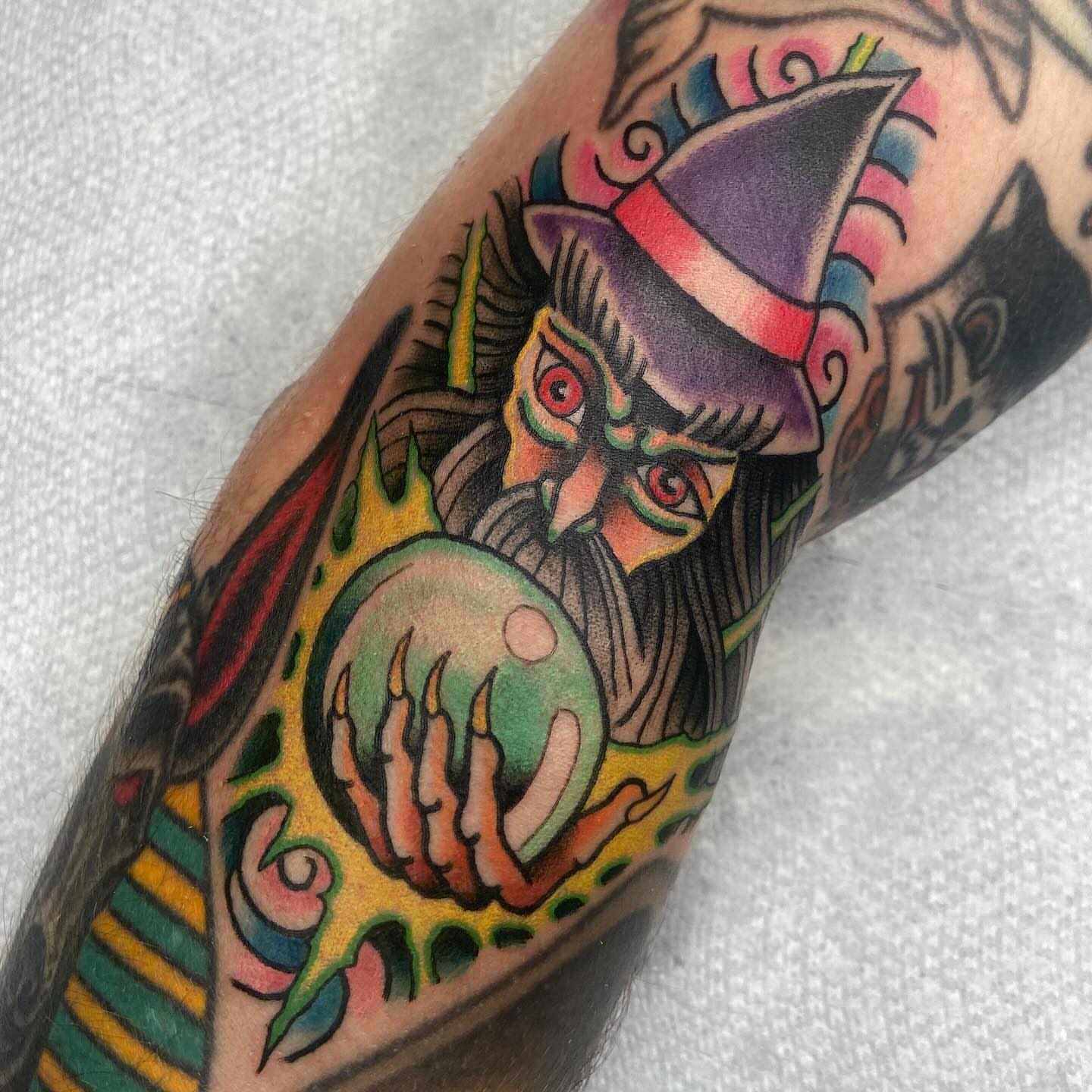 Clown with crystal ball American traditional tattoo on the forearm by nicholas mcevoy, Boston, Massachusetts
