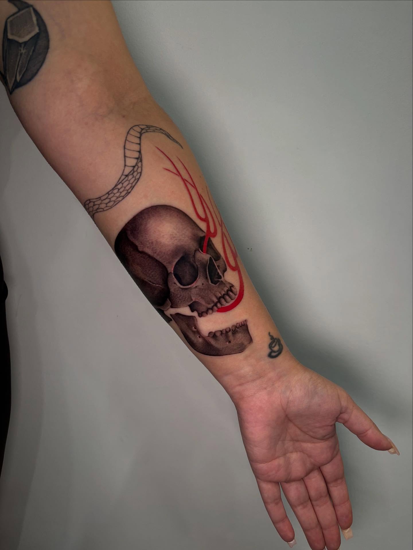 Skull with flame realism tattoo on the forearm by @piinkywabbiit, Roselle Park, New Jersey