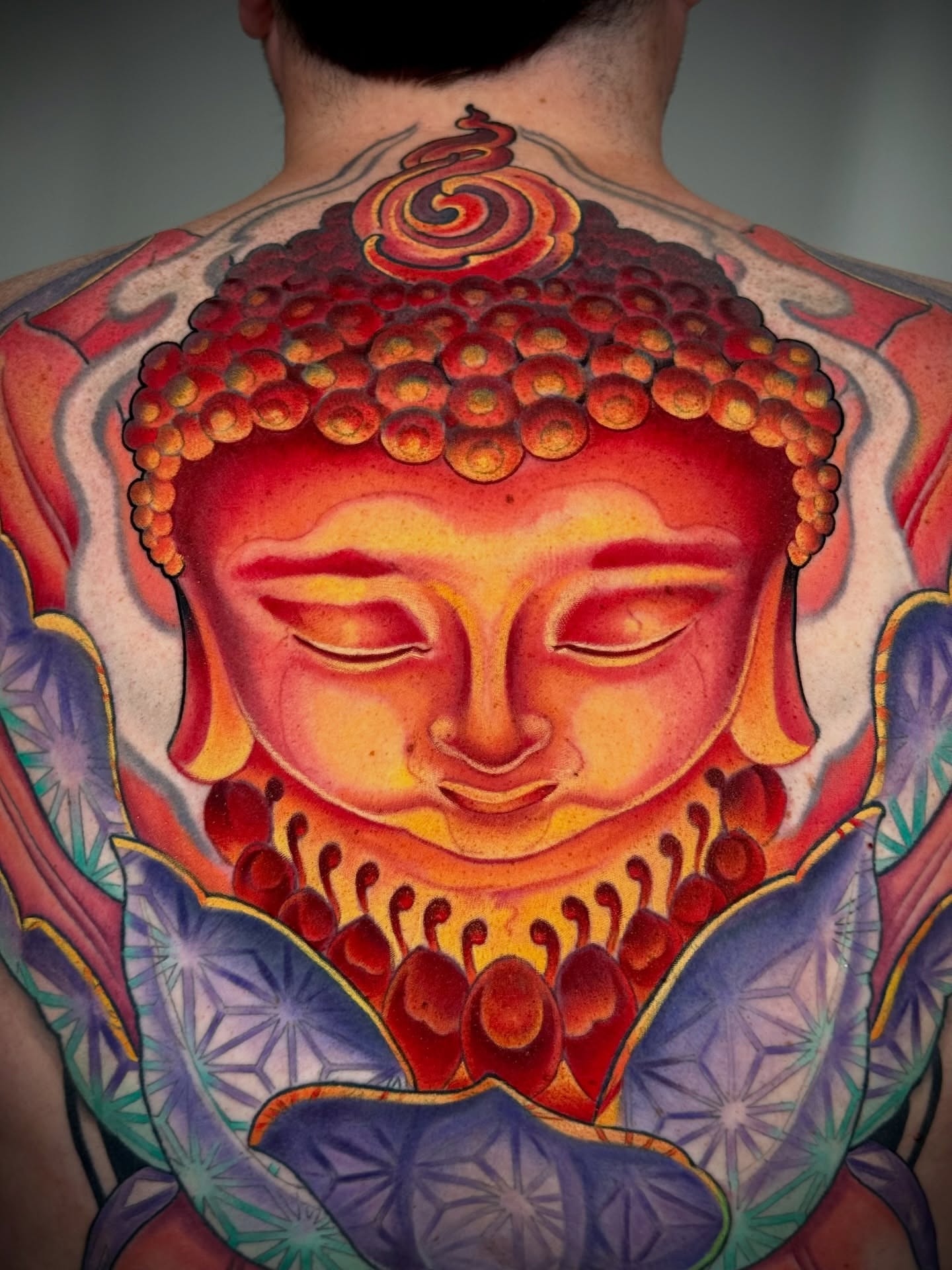 Buddha head dotwork tattoo on the back by Melis Fusco