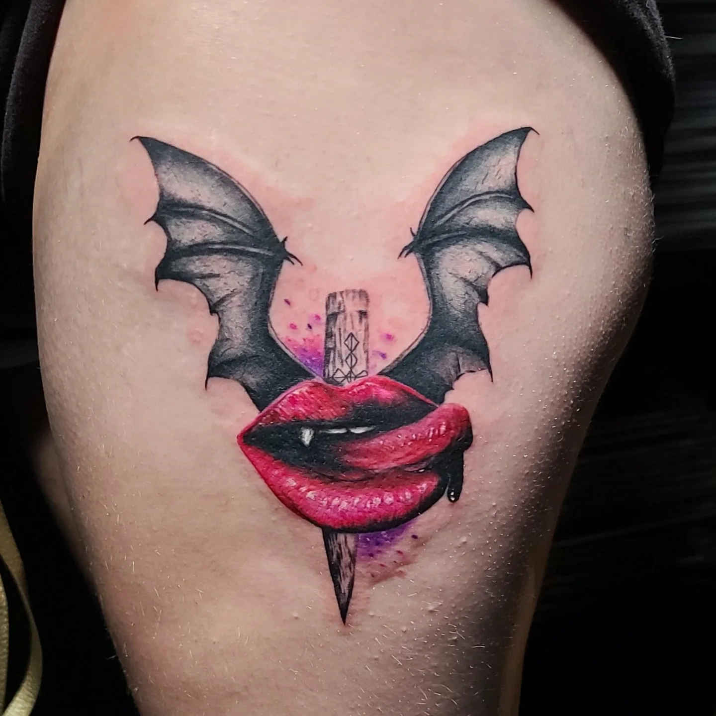 Bat wings and lips dark realism tattoo on the thigh by Drew King