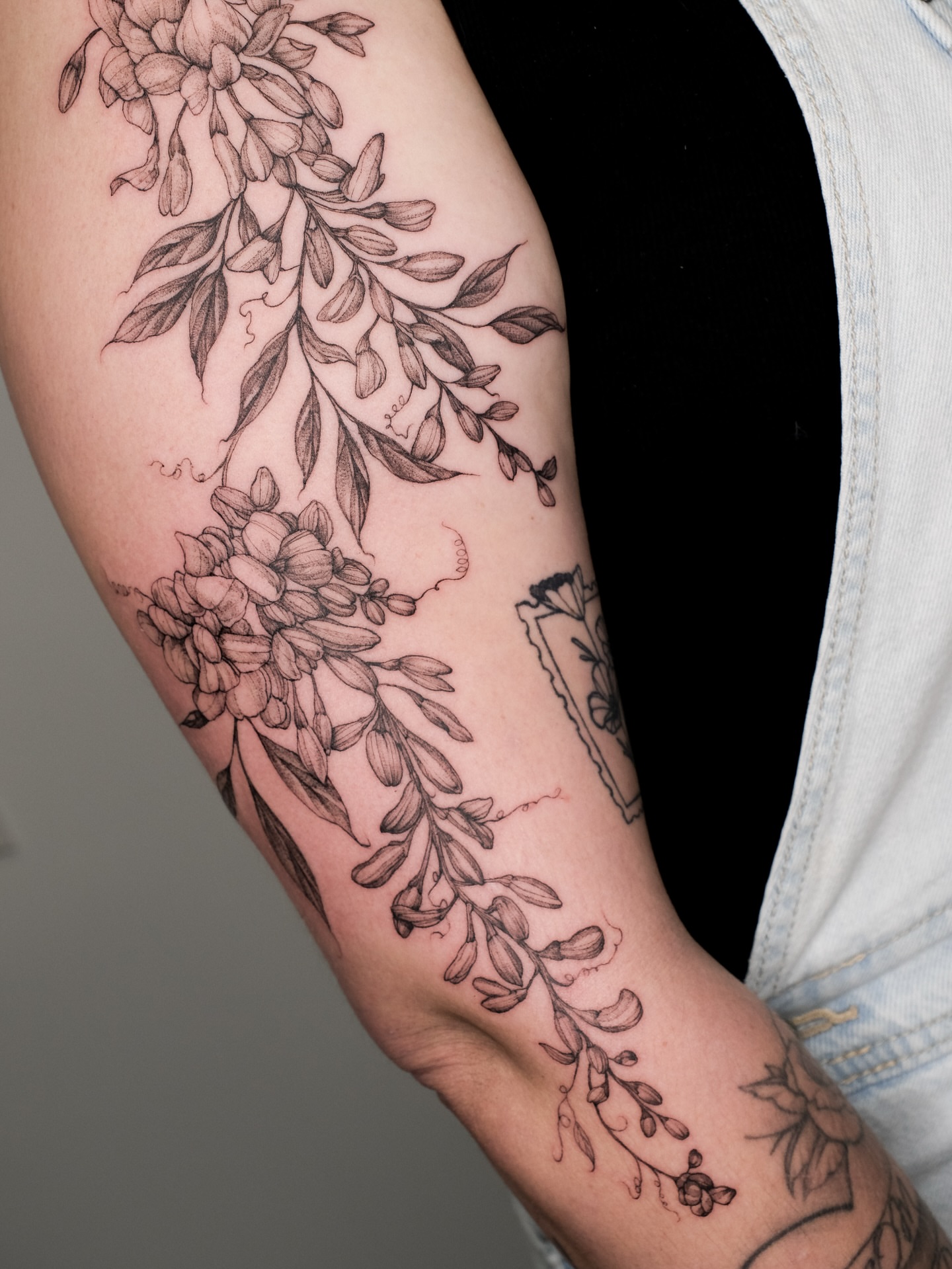 Floral arrangement black and grey tattoo on the forearm by Emma- Los Angeles Tattoo Artist