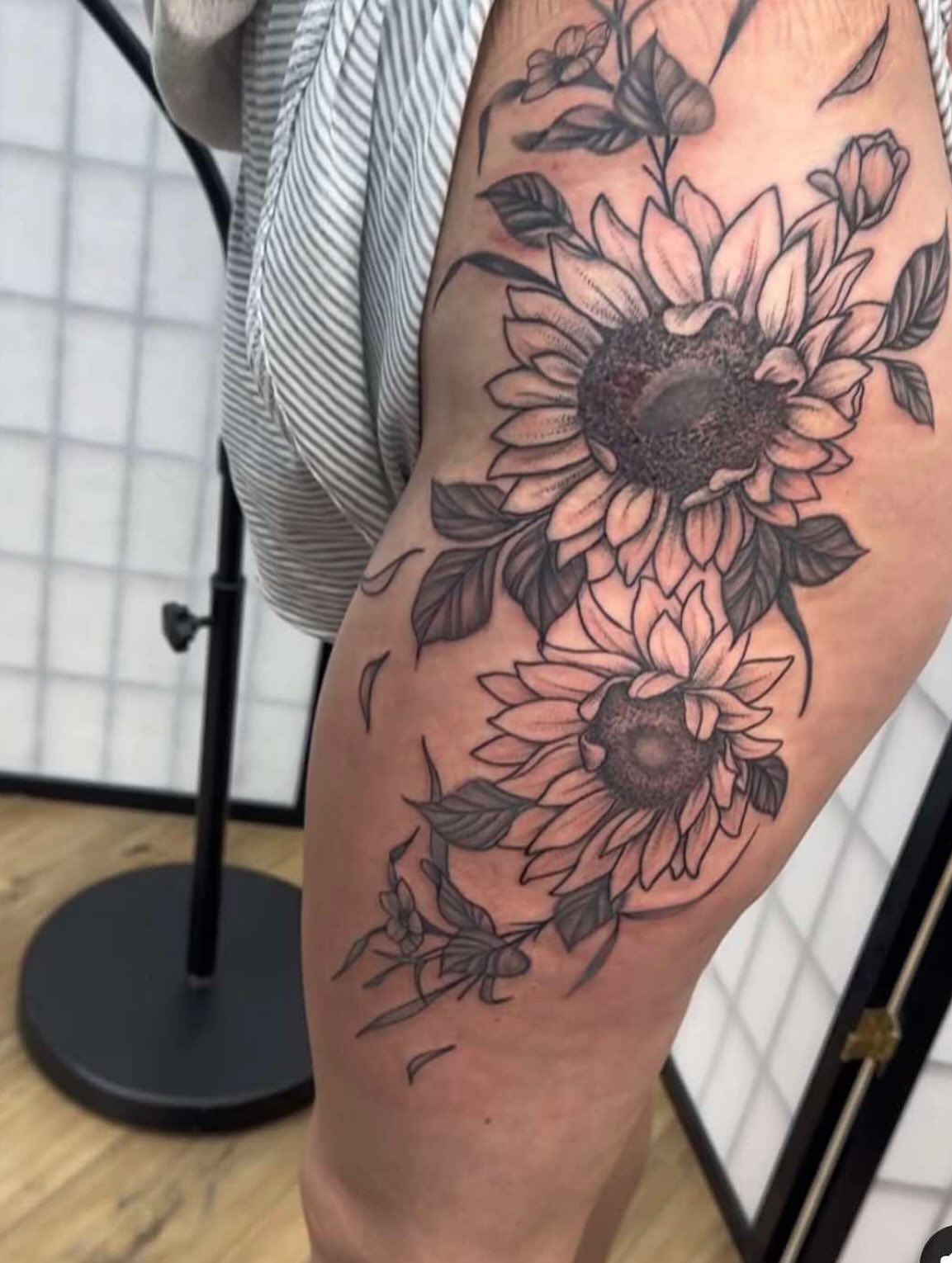 Sunflowers black and grey tattoo on the thigh by TC 🧚🏽, Columbus, OH