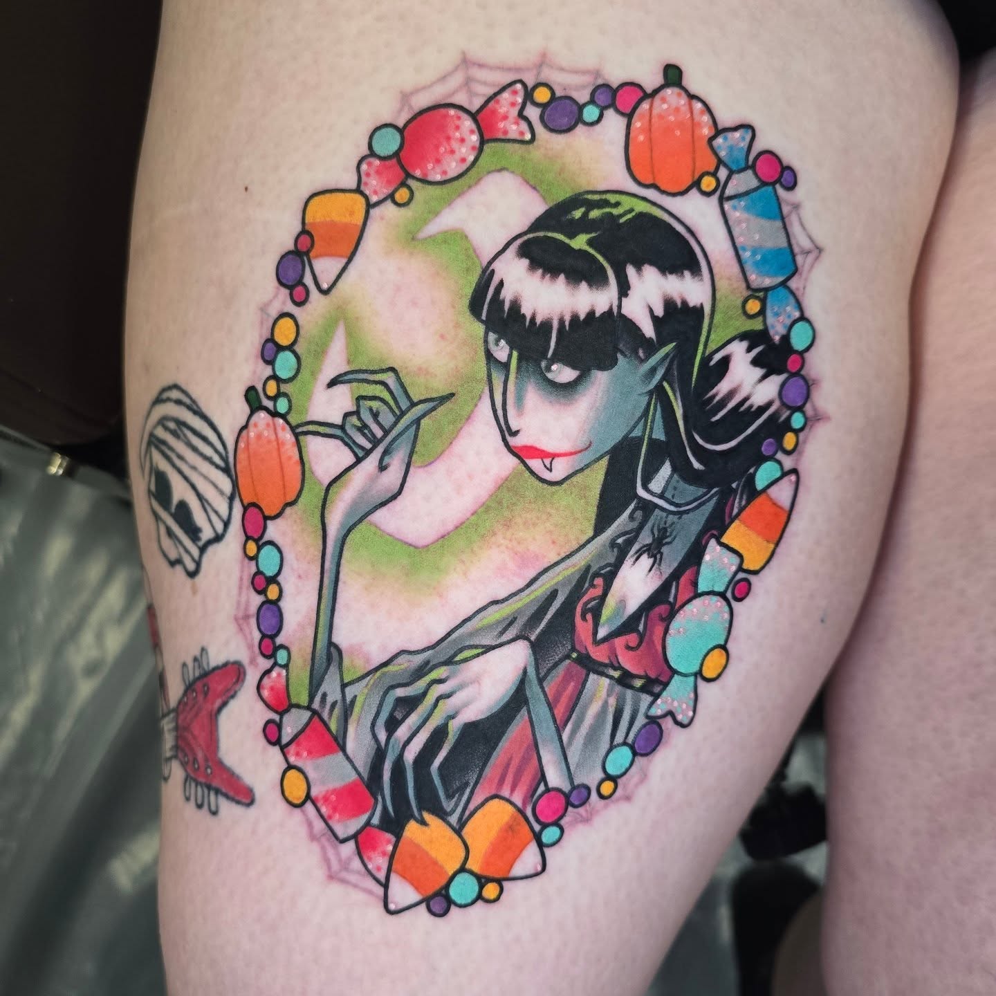 Geisha with candy corn illustrative tattoo on the thigh by Justin Eldridge