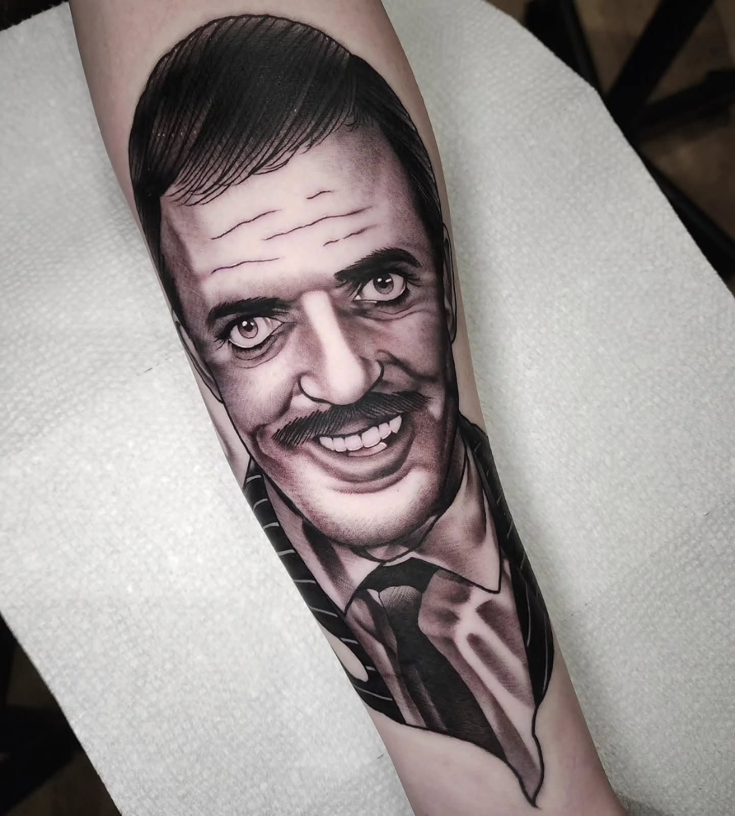 Portrait realism tattoo on the forearm by Justin Eldridge