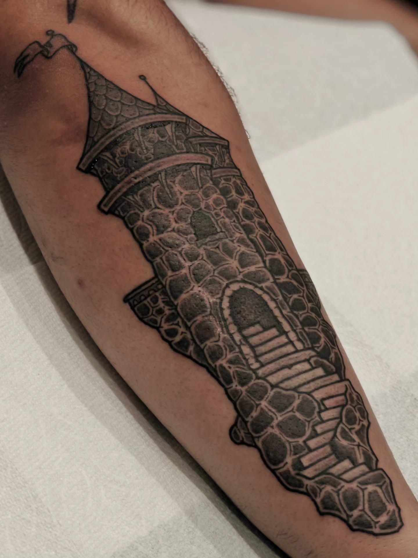 Tower black and grey tattoo on the forearm by Tattoos by Reed Blount