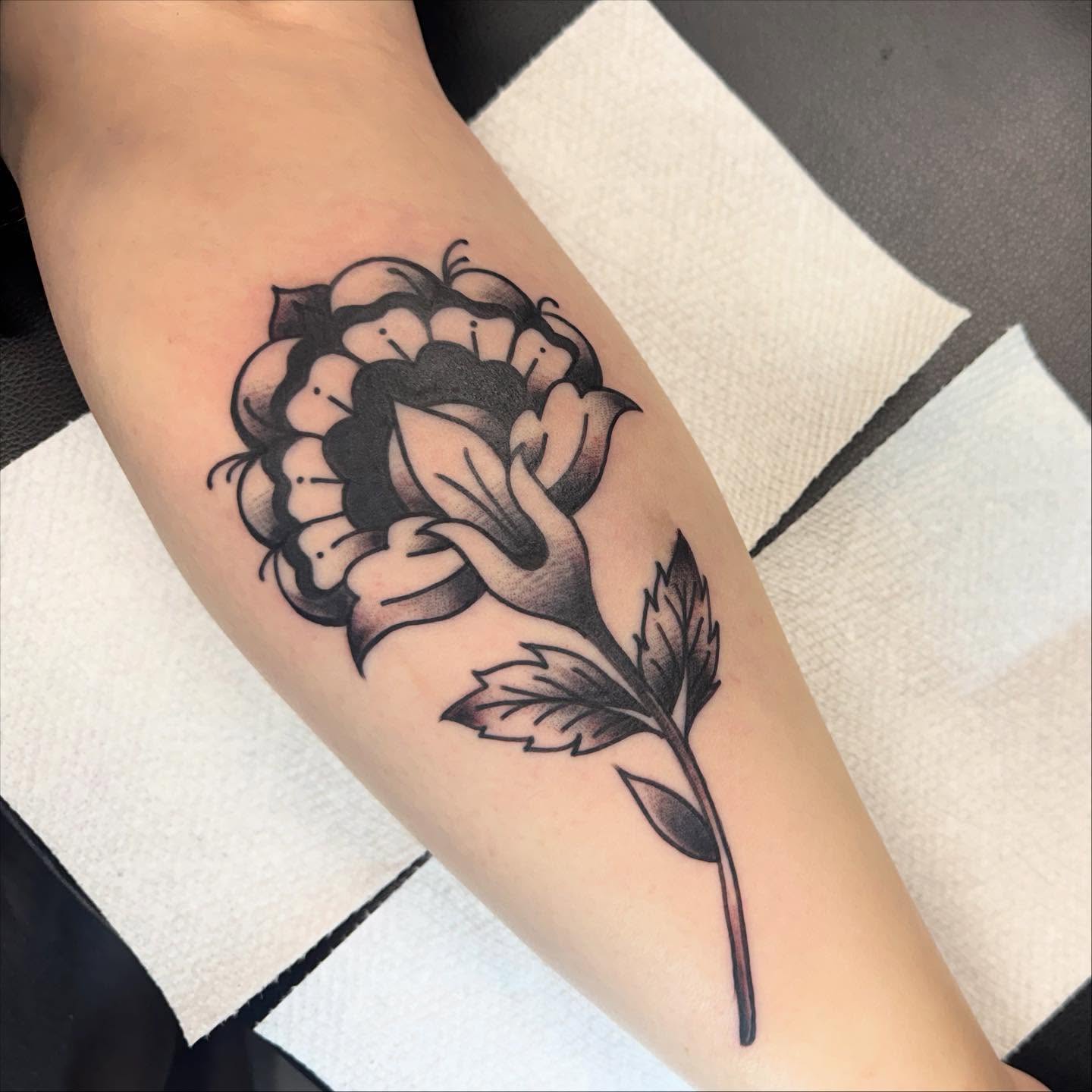 Peony black and grey tattoo on the forearm by 𝗞𝗮𝘁 𝗕𝗹𝗮𝗻𝗸𝗲𝗻𝘀𝗵𝗶𝗽