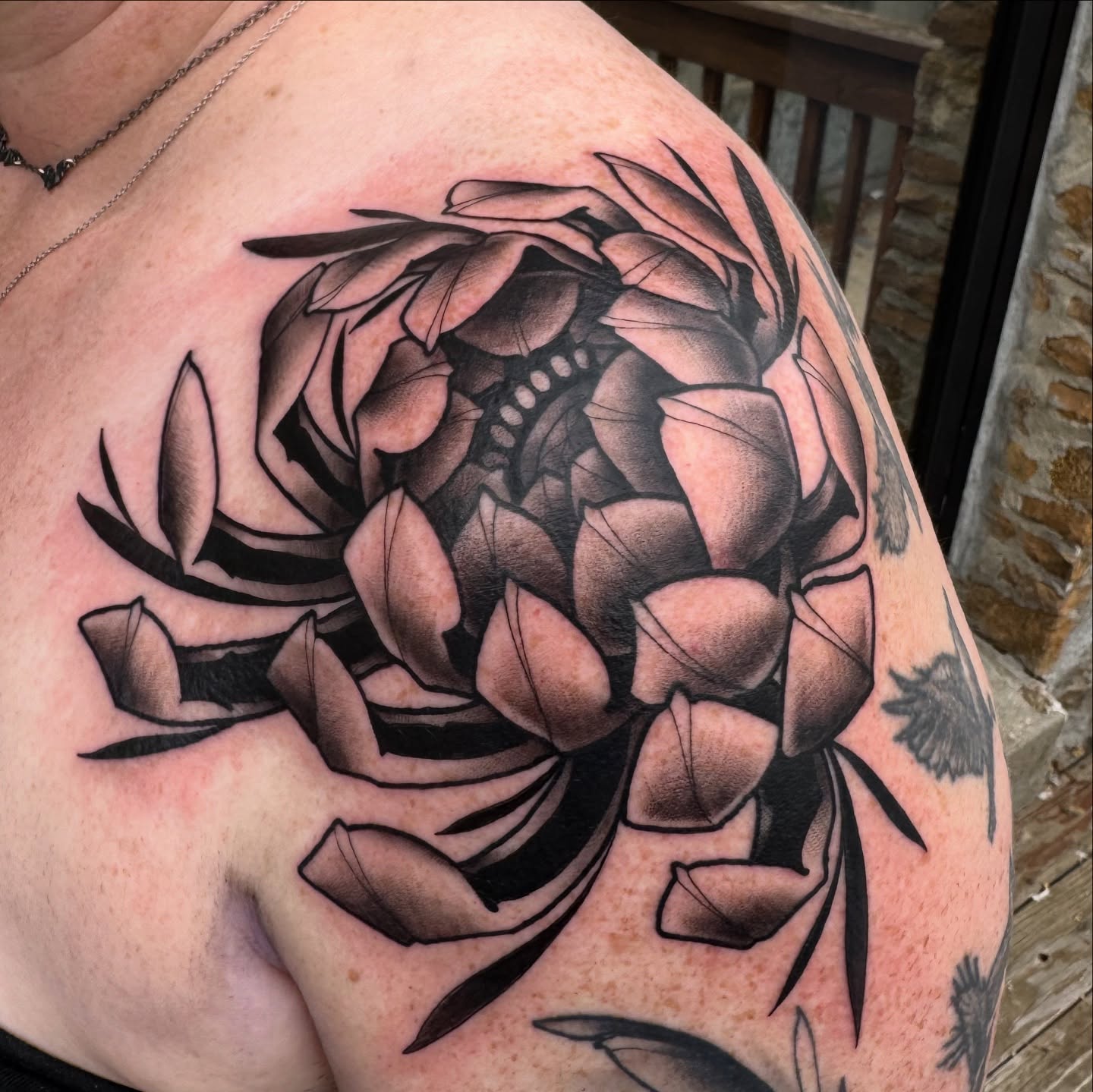 Flower black and grey tattoo on the shoulder by Erin Bratzler