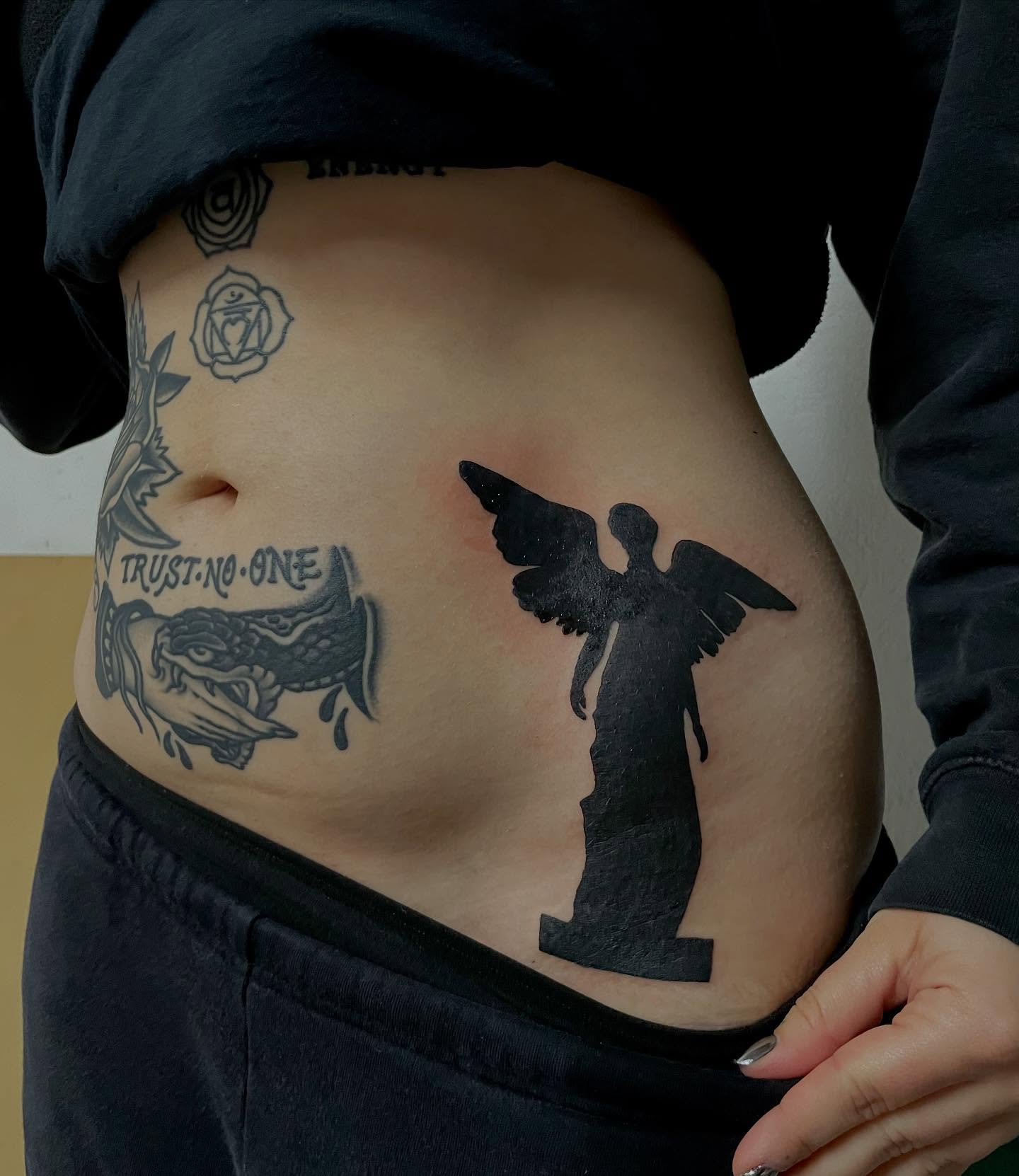 Angel statue black and grey tattoo on the torso by bisabuelita