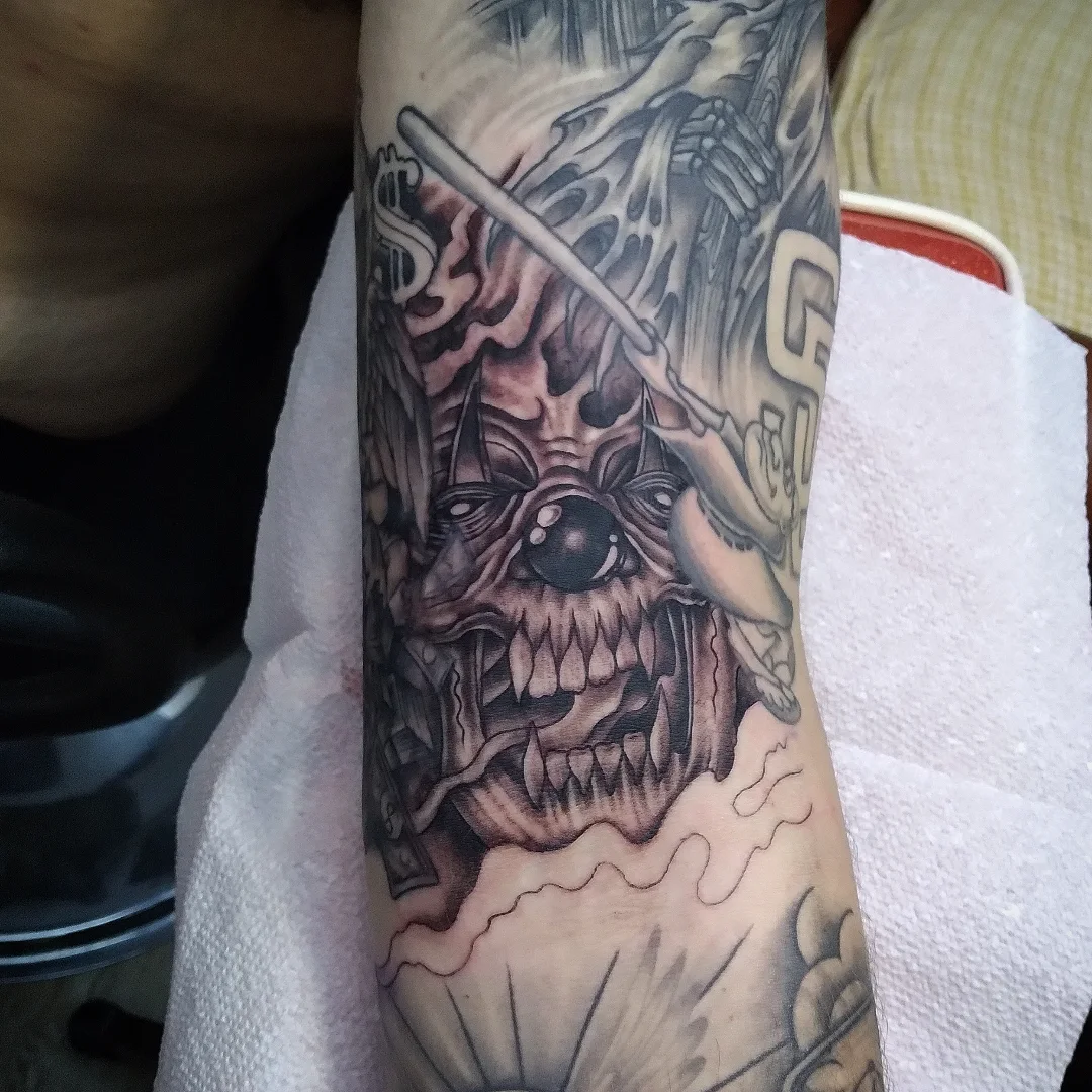 Demon face dark realism tattoo on the forearm by Josh Sroga