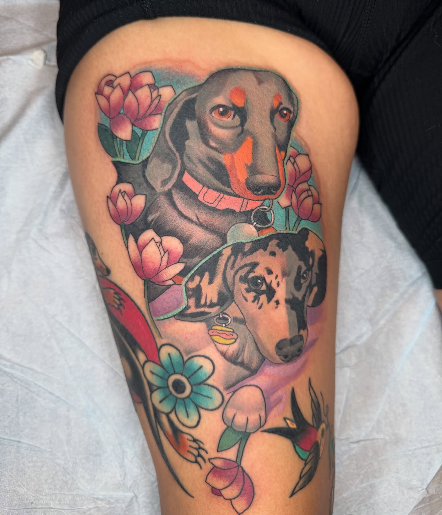 Dogs and flowers American traditional tattoo on the thigh by Seattle Tattoo Artist, Bonney Lake, Washington