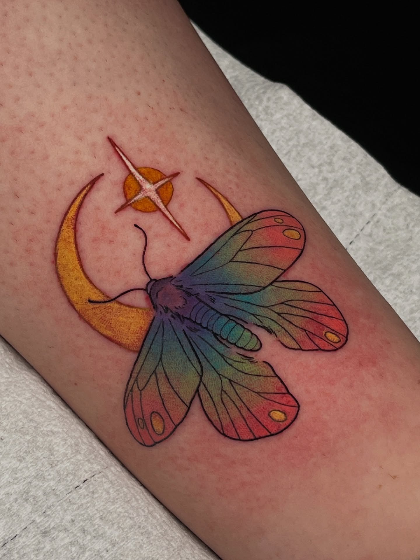 Butterfly and crescent moon new school tattoo on the forearm by Summer Machelle, Orange, California