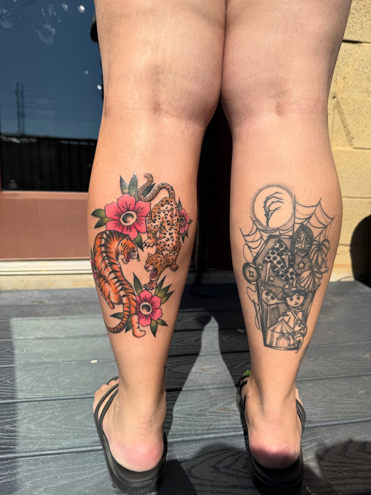Tiger and leopard with flowers American traditional tattoo on the calf by Nathalie Briseno