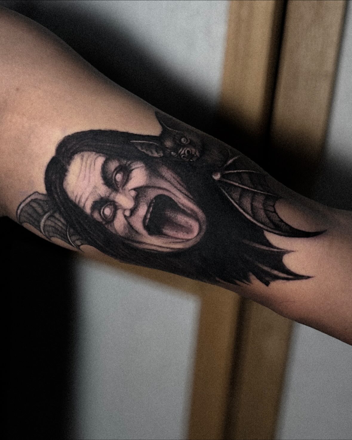 Horror clown dark realism tattoo on the forearm by La Hyene