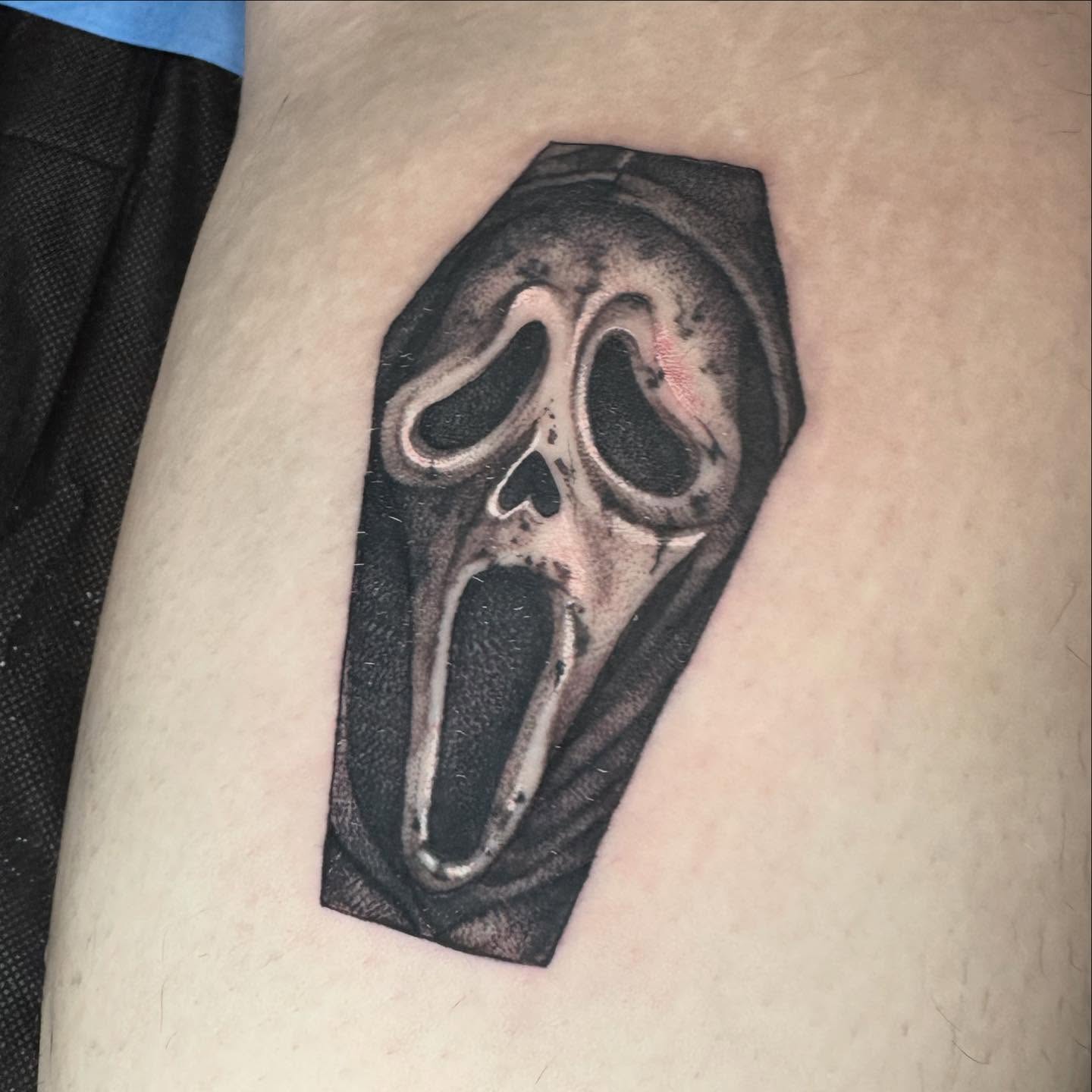 Mask realism tattoo on the thigh by Ryan Futterman