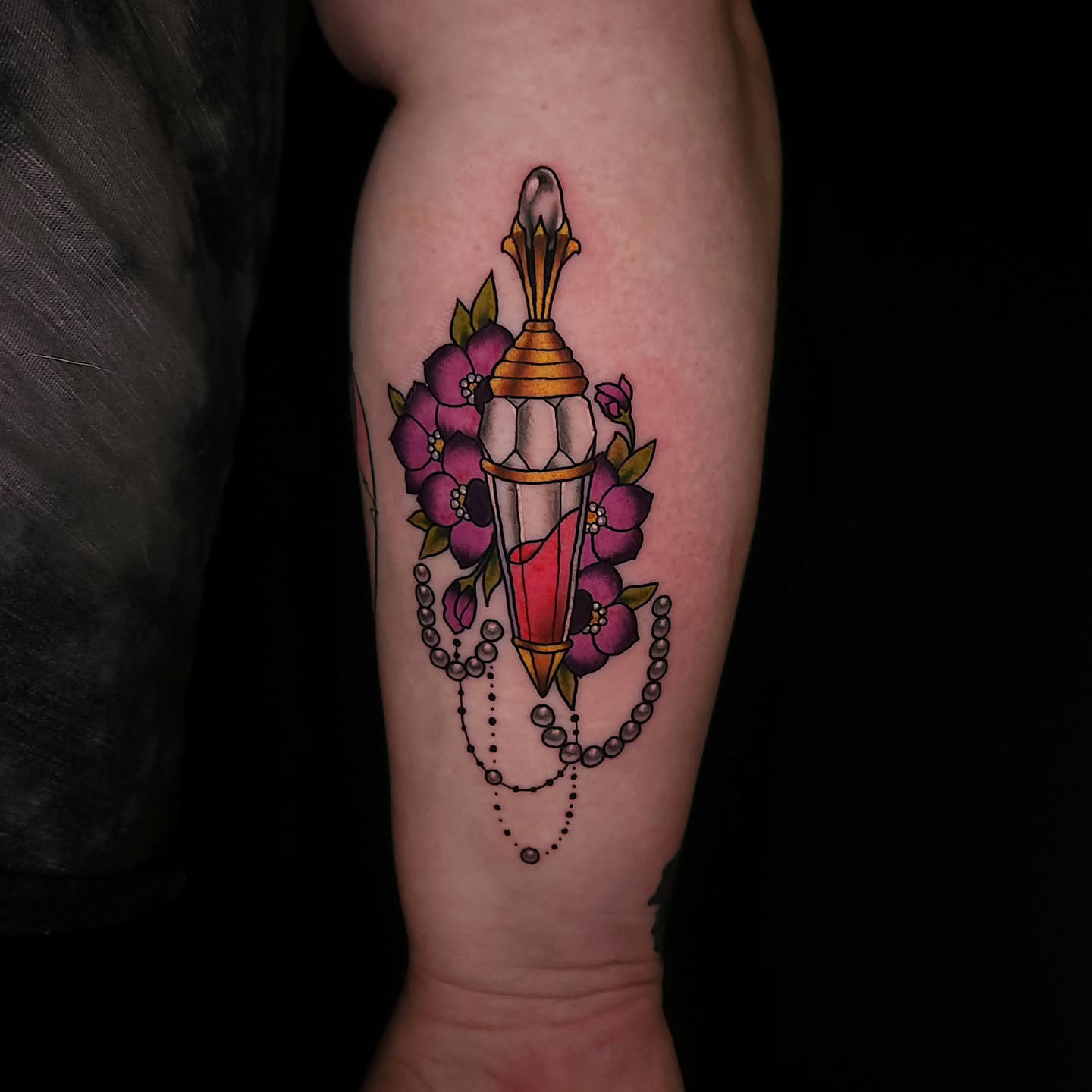 Lamp with flowers American traditional tattoo on the forearm by Sheena Yu-Hsin Wood