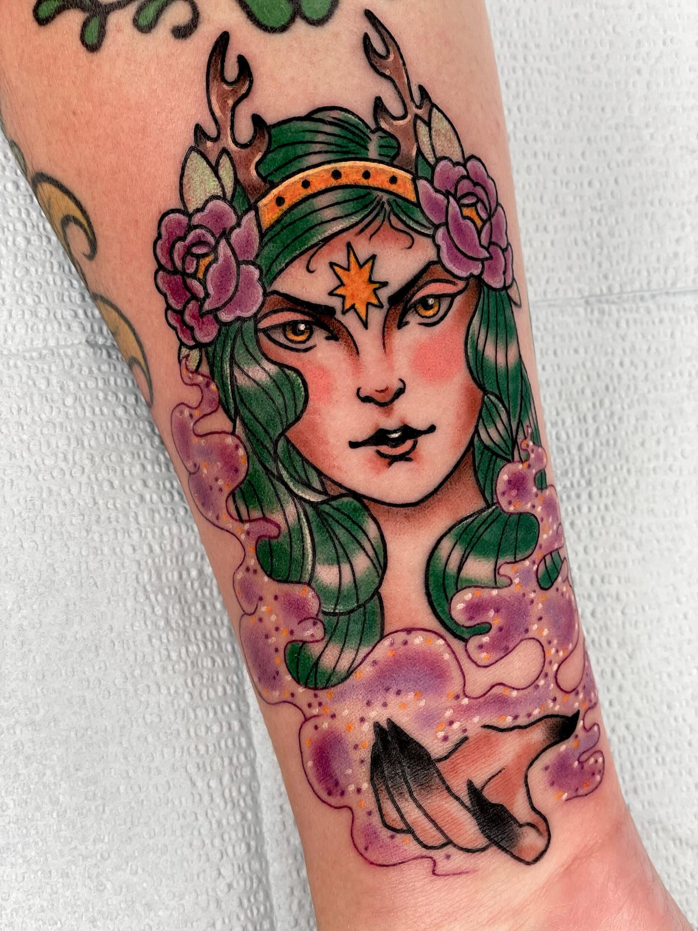 Woman with deer antlers American traditional tattoo on the forearm by Beeker, Bellingham, Washington