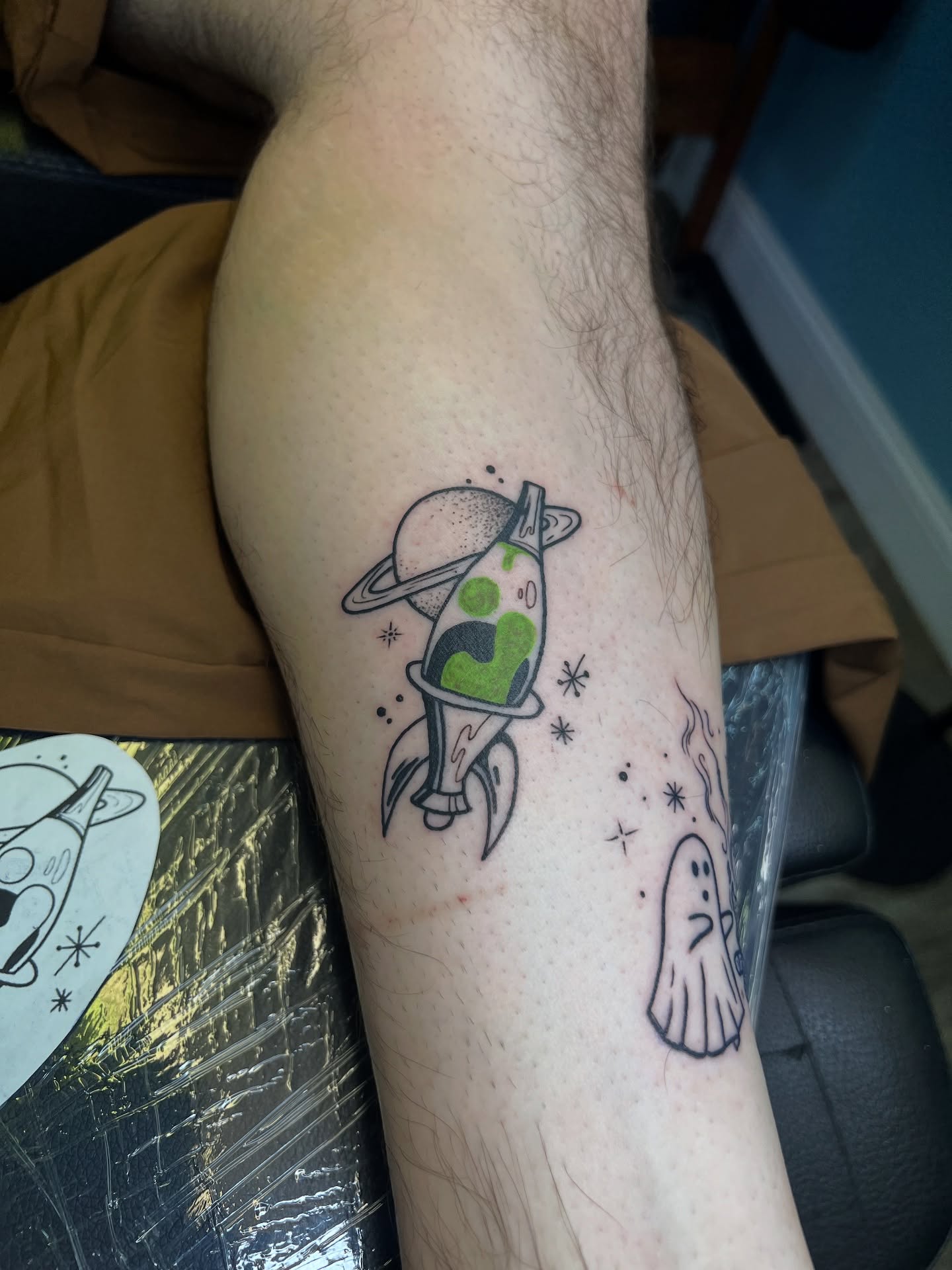 Space rocket and ghost dotwork tattoo on the forearm by Tattoo Artist