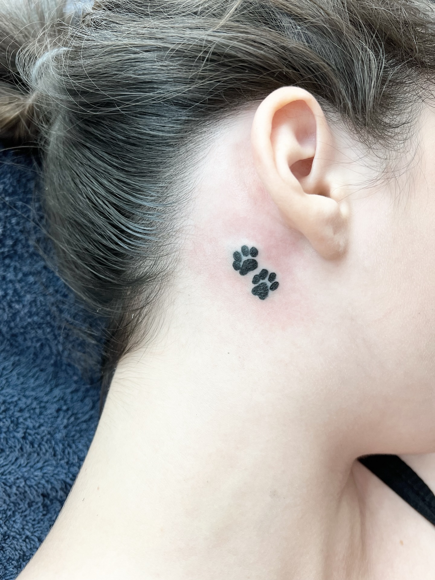 Paw print dotwork tattoo on the neck by Sacramento tattoo