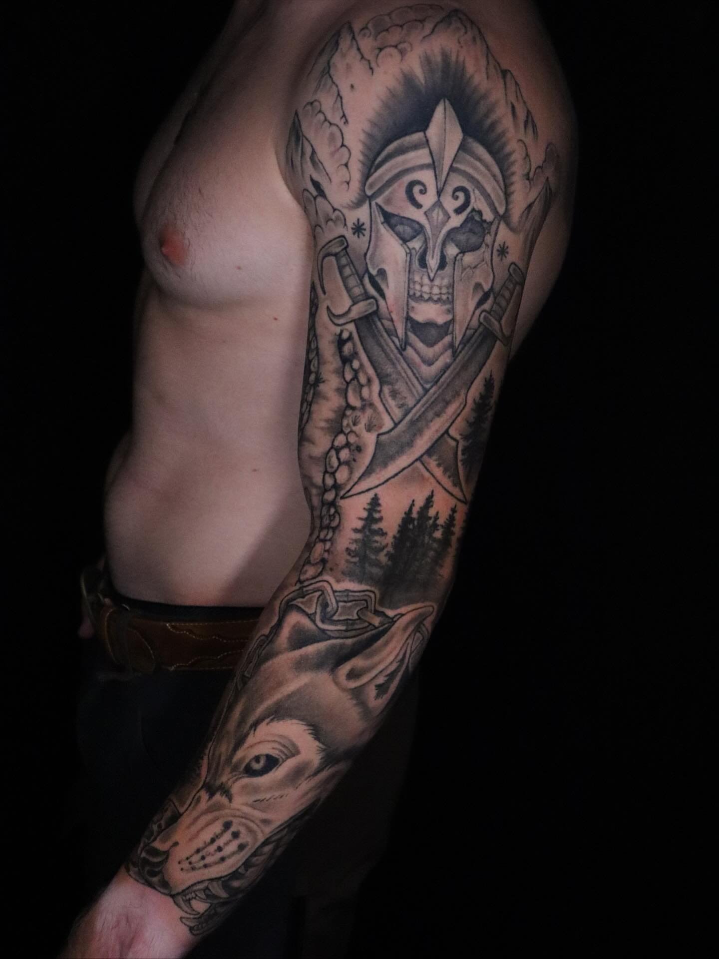 Warrior skull with wolves realism tattoo on the forearm by Brandon Seven