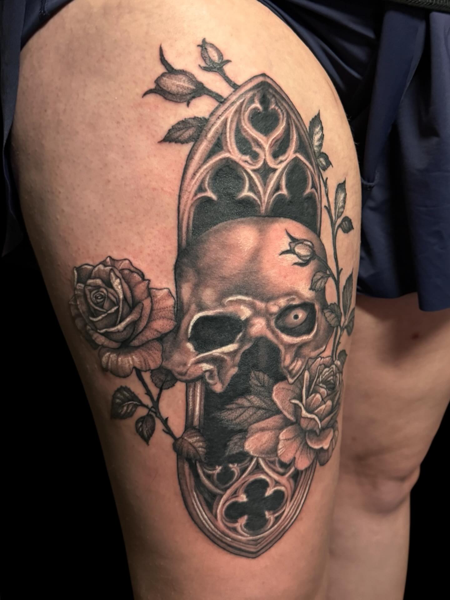 Skull and roses realism tattoo on the thigh by Brennan Walker, Orem, Utah