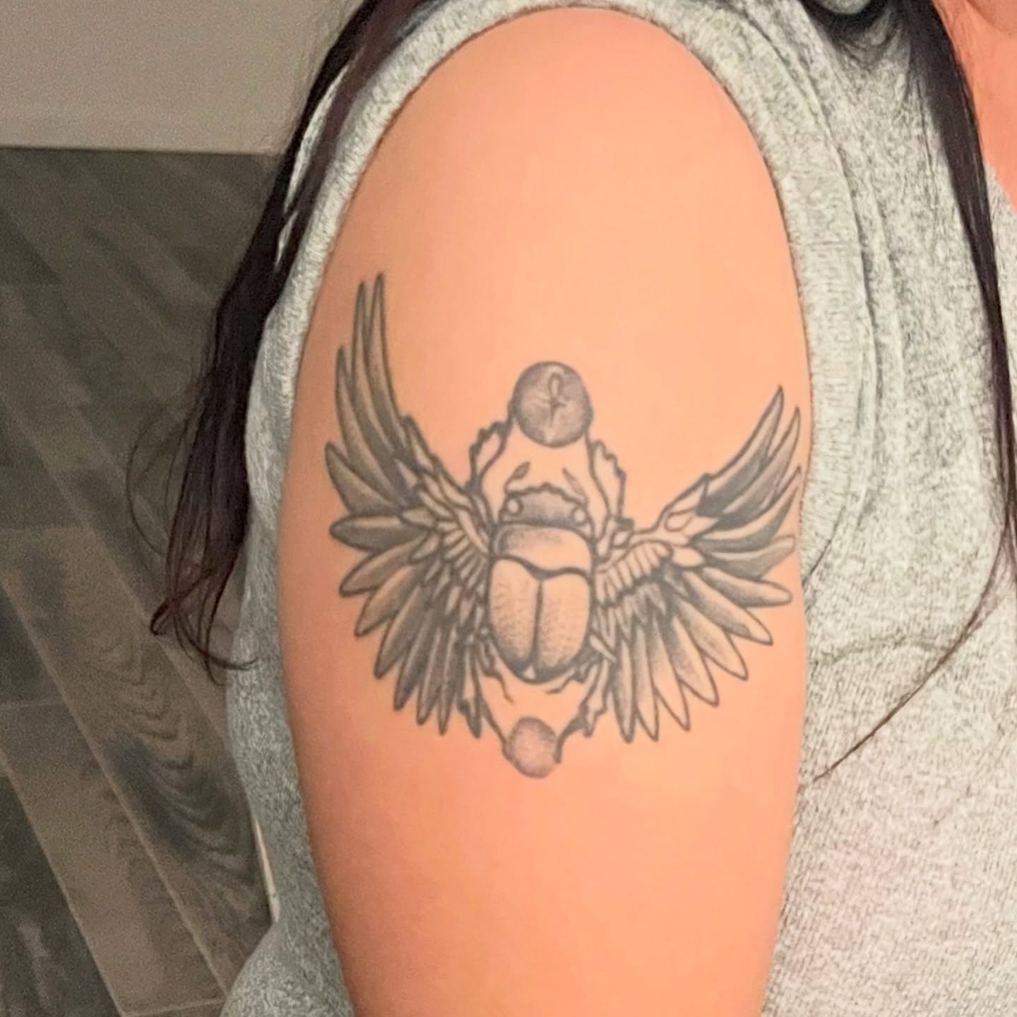 Scarab beetle with wings black and grey tattoo on the shoulder by Sacramento tattoo