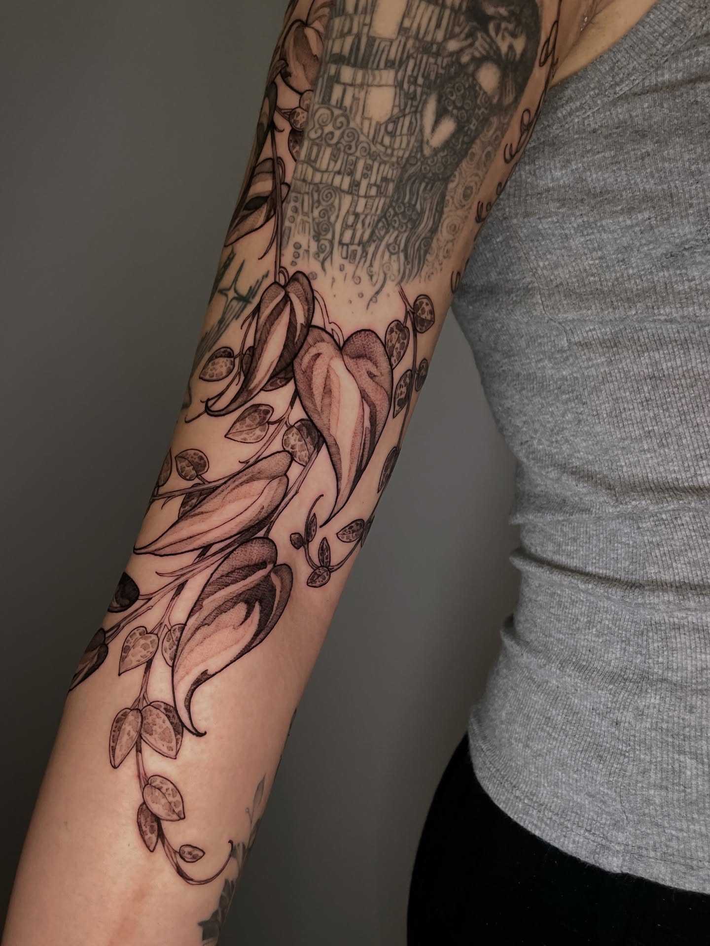 Floral vine realism tattoo on the forearm by Carol Jacky